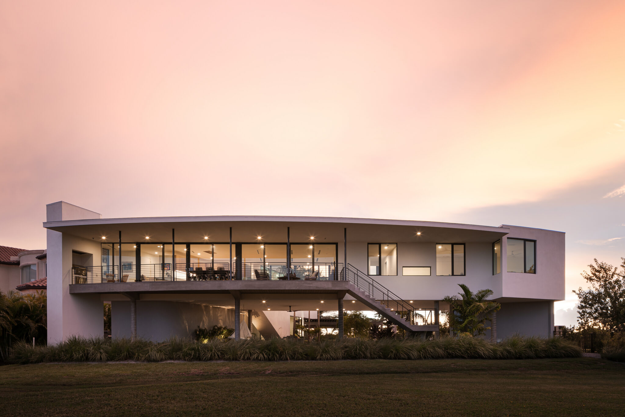 Rear of Palma Sola Modern under a pink sunset sky