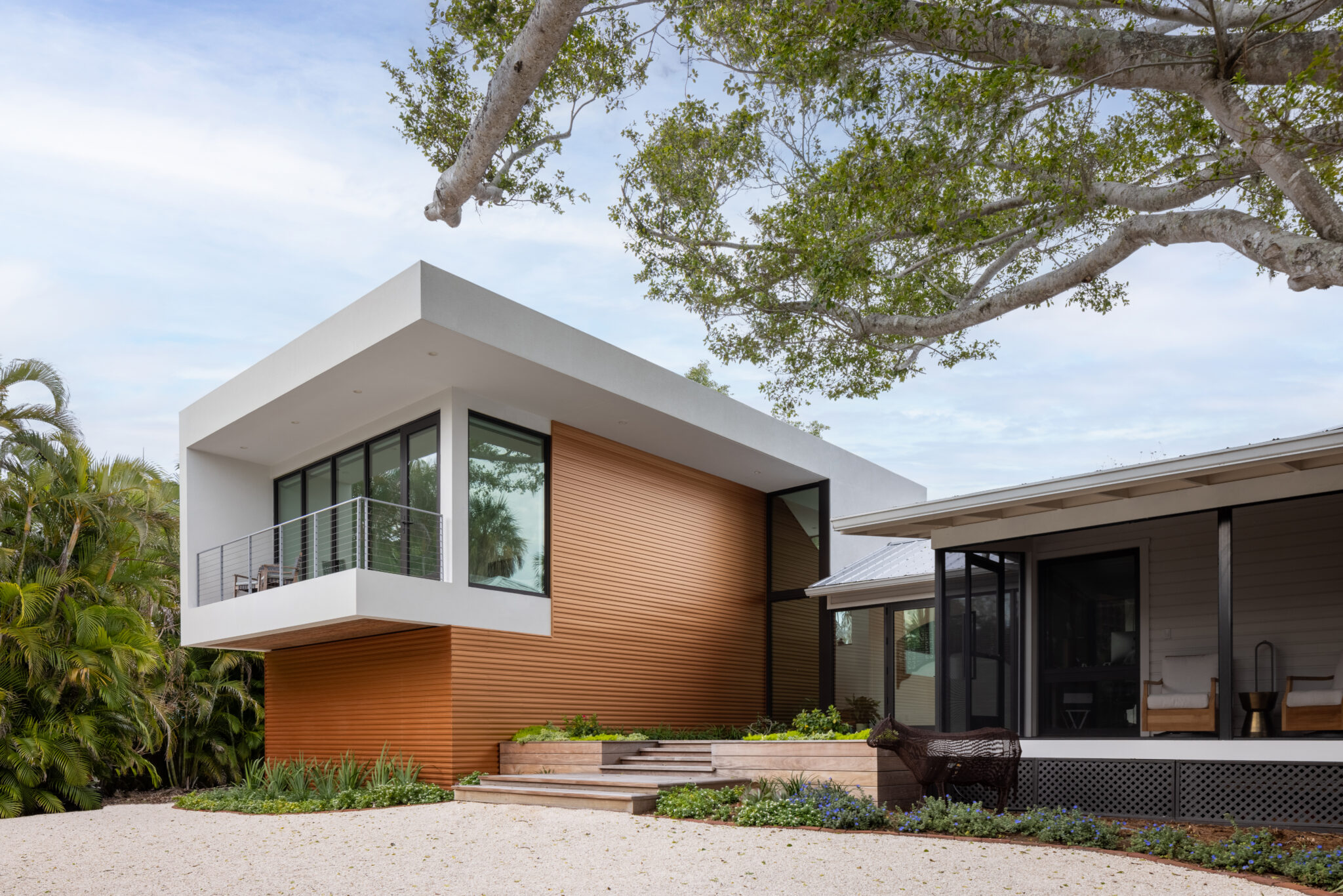 Schoolhouse Modern beside the original 1926 schoolhouse under a live oak