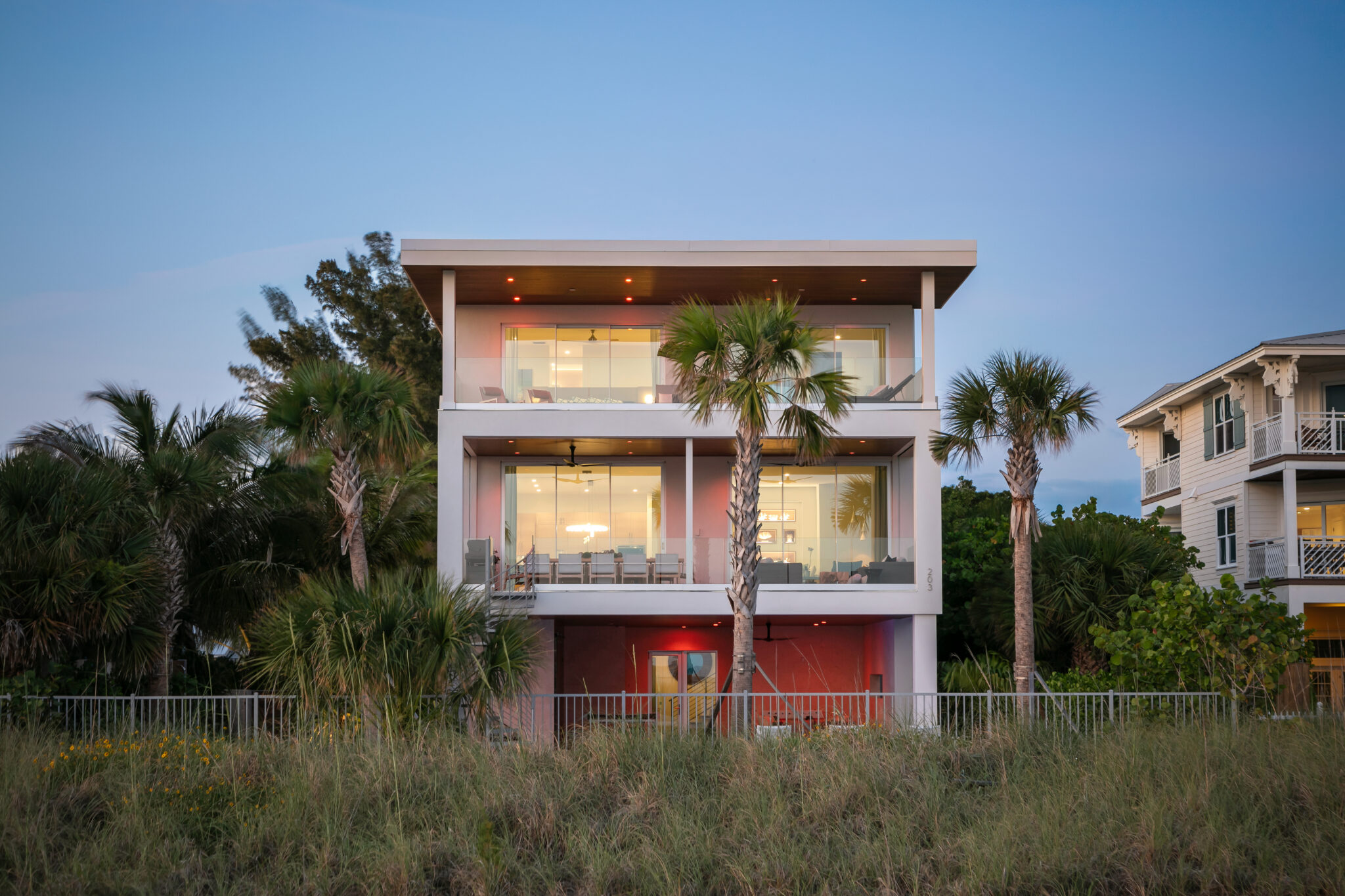 Sundowner Beach from the dunes at dusk, a modern three-story beach house