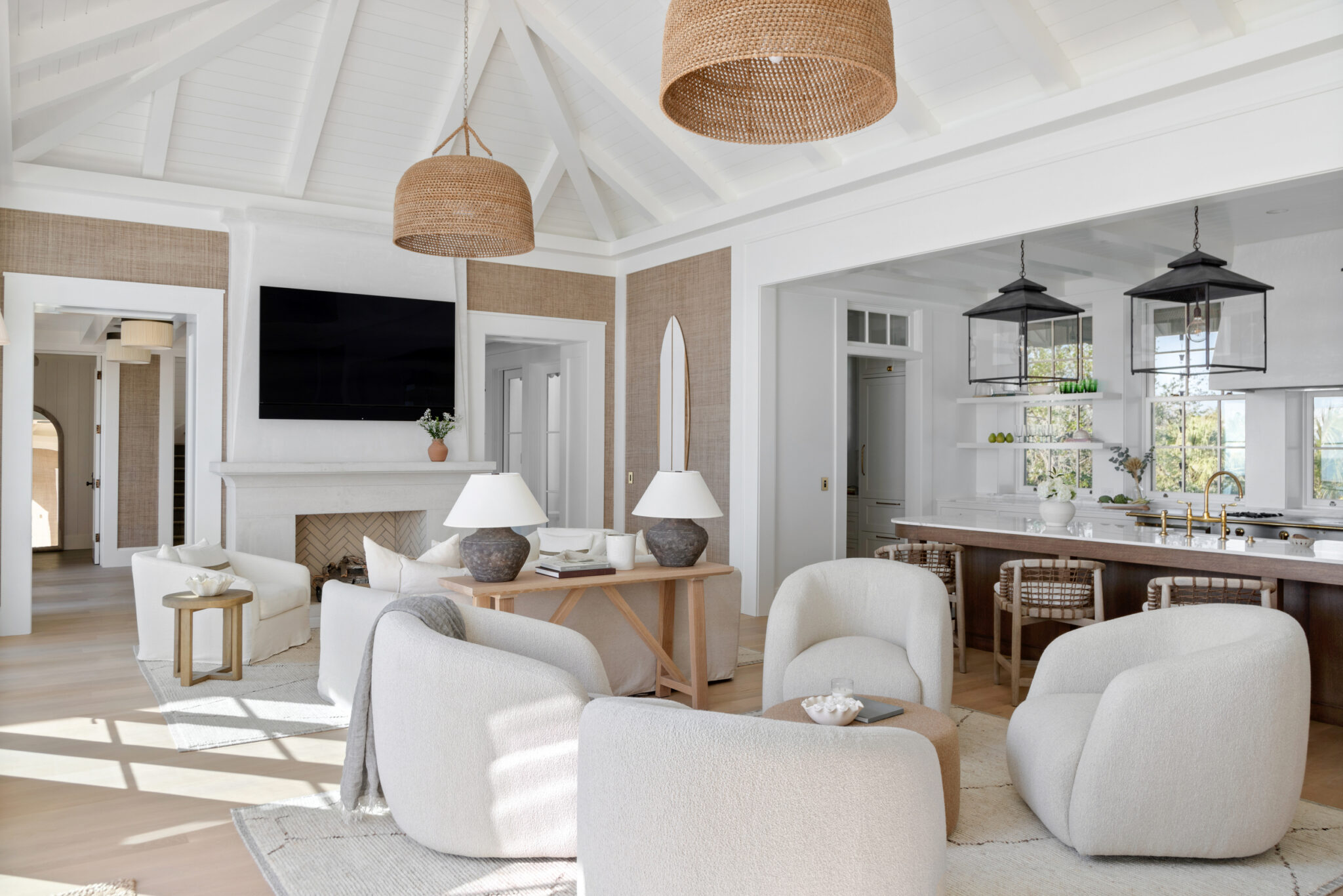 Living room with curved swivel chairs, open to the kitchen