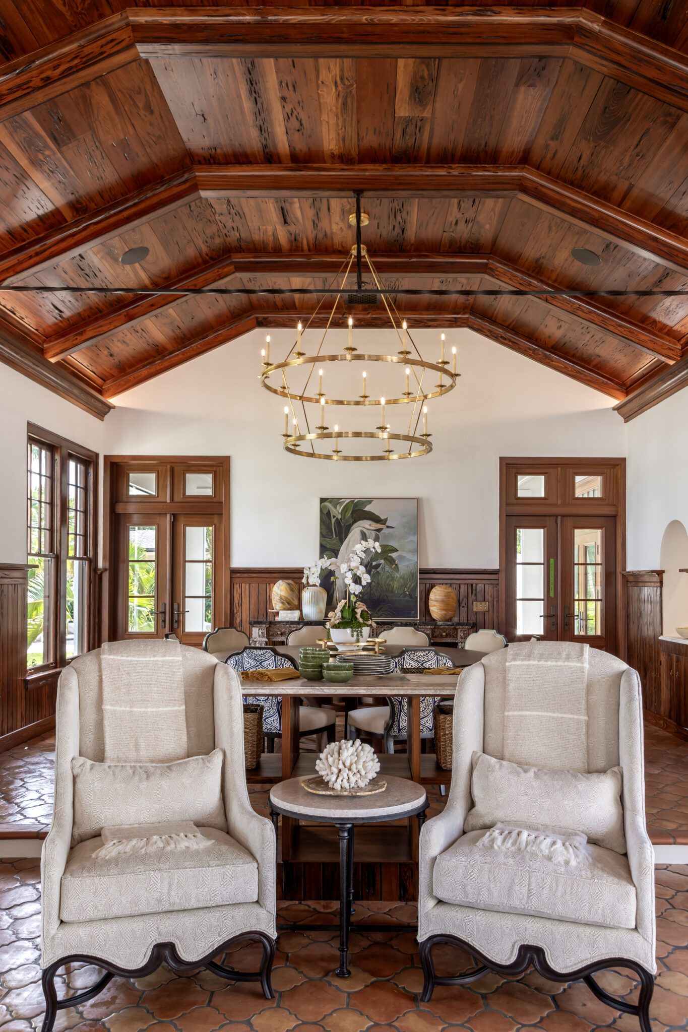 Sitting area with paired armchairs under a beamed wood ceiling