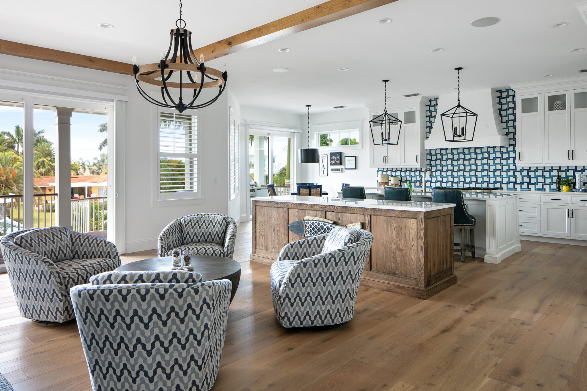 Living area with patterned swivel chairs, open to the kitchen