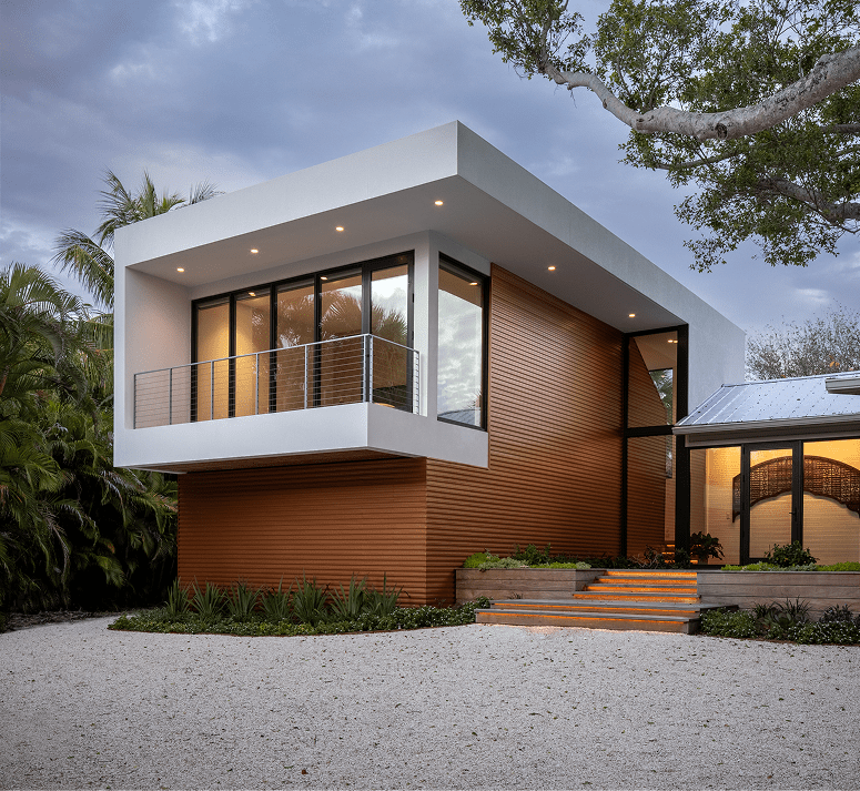 Schoolhouse Modern addition, a white cantilevered box over wood siding