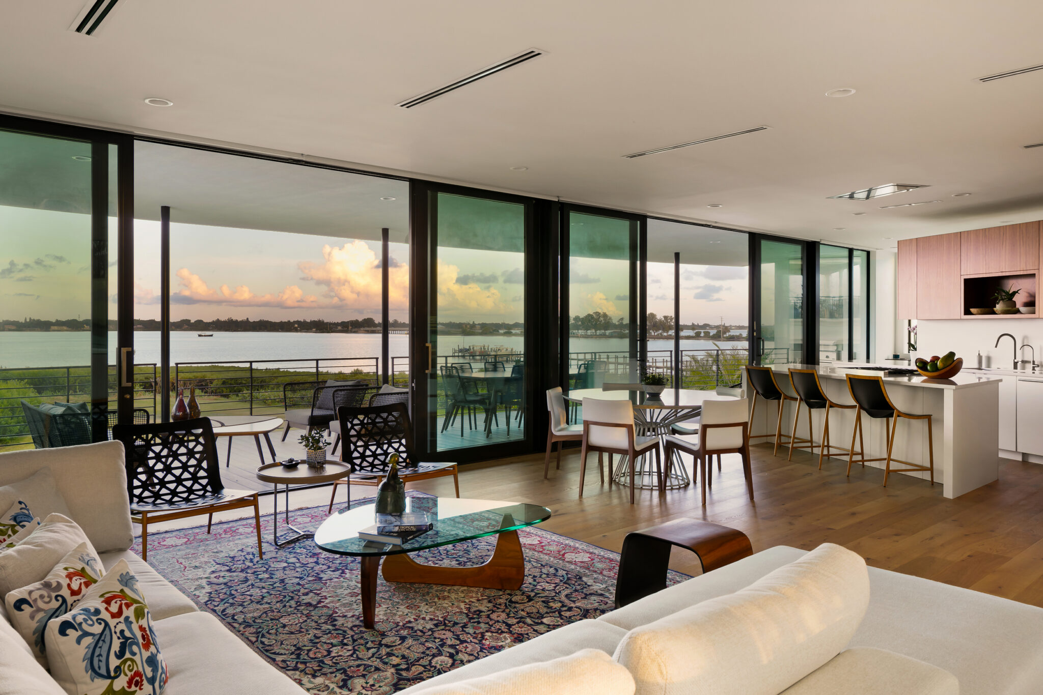 Living room with walls of sliding glass onto the bay