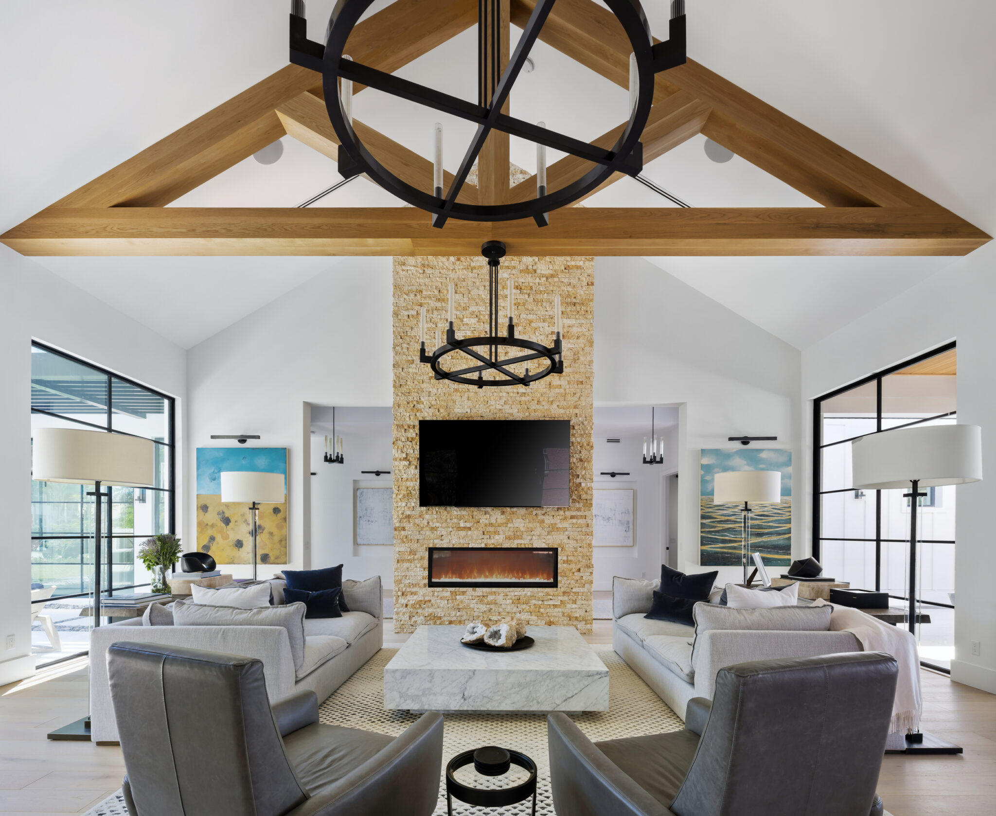 Living room with a stone fireplace column under timber trusses