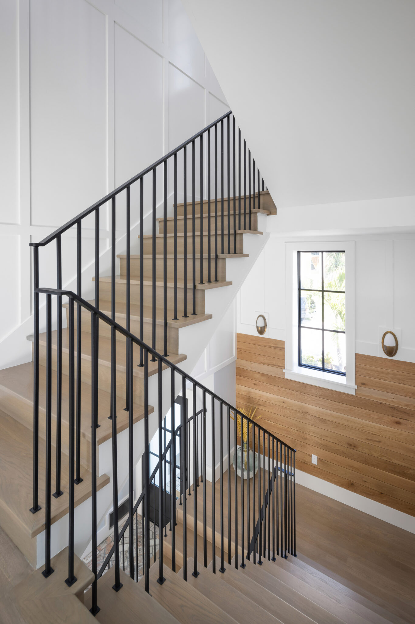 Open stair with white oak treads and slim black rails