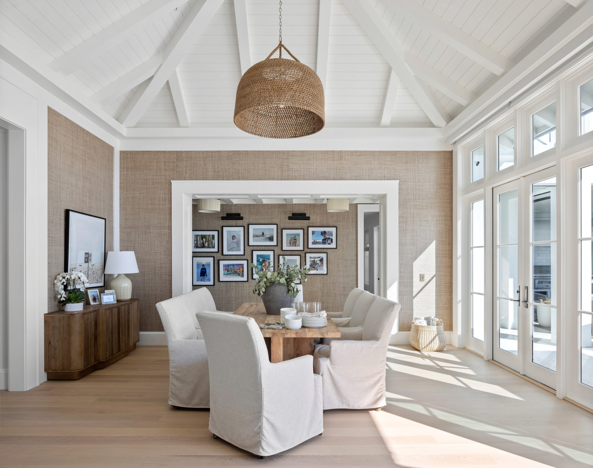 Sitting room with grasscloth walls and a framed gallery wall
