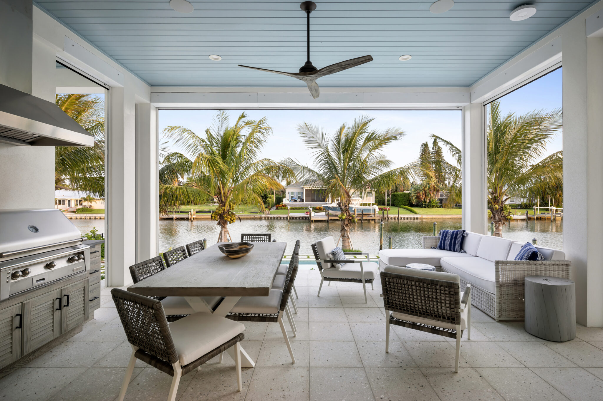 Covered outdoor kitchen and dining area overlooking the canal