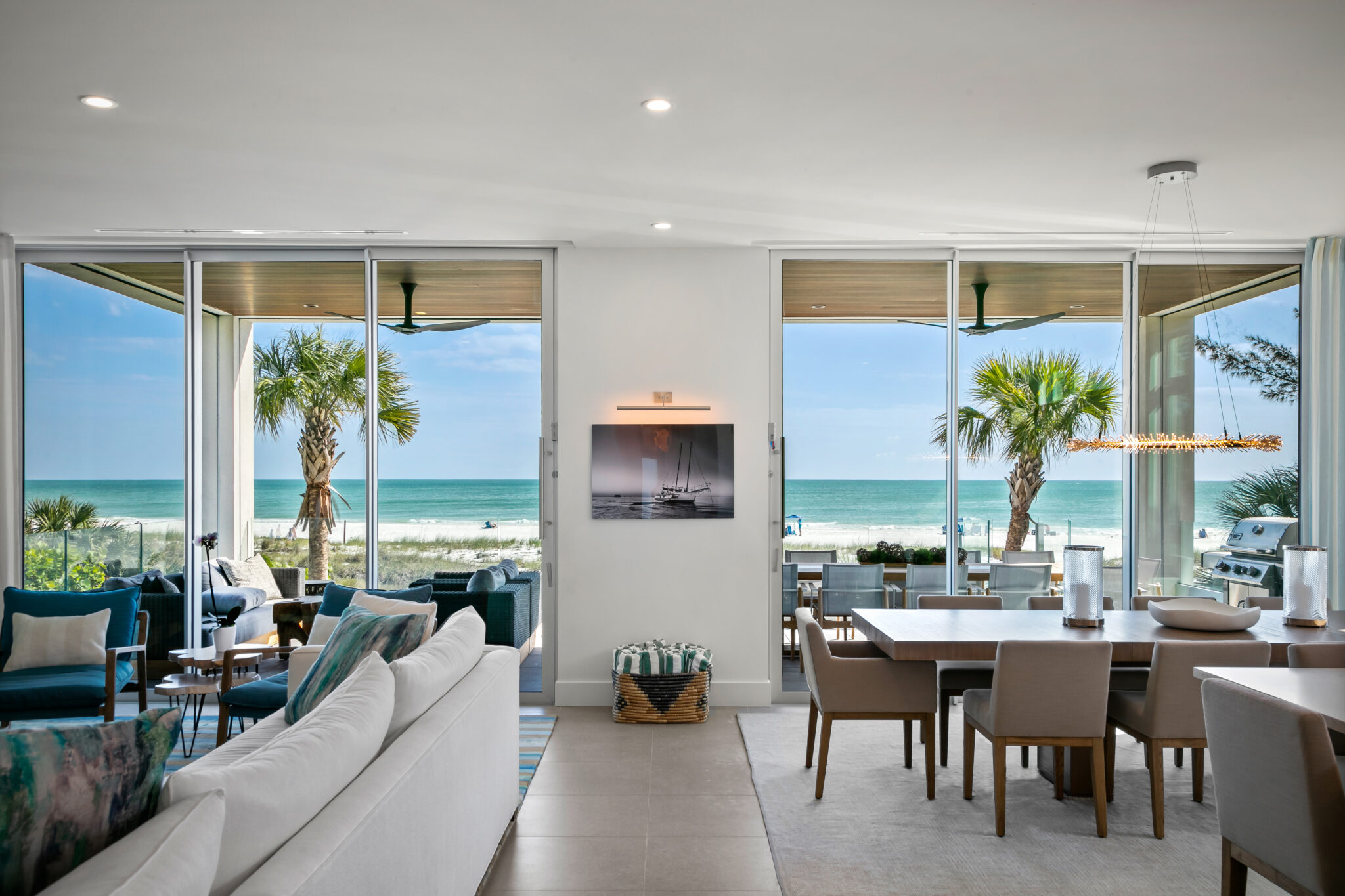 Living and dining room with walls of glass facing the Gulf