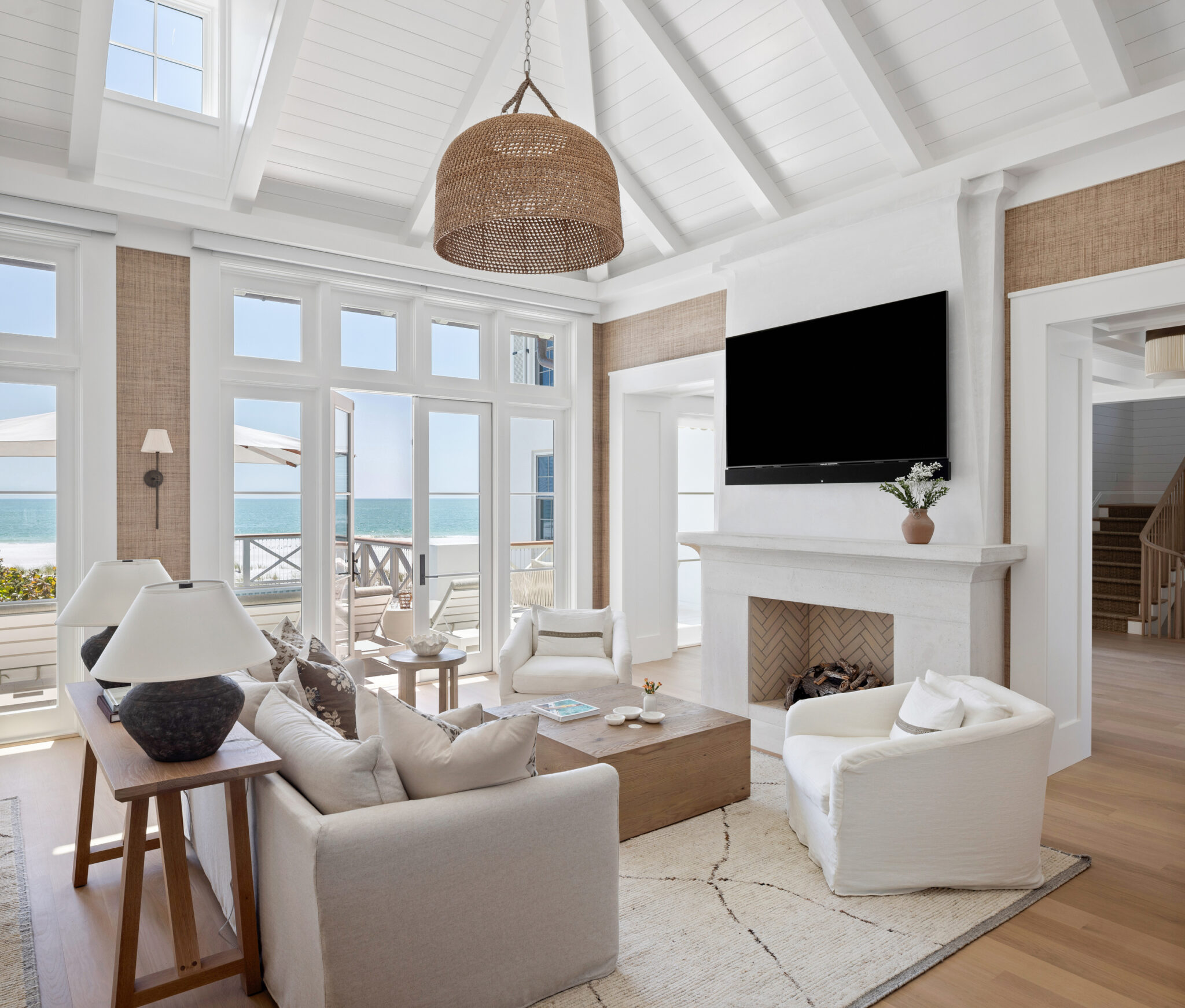 Living room with fireplace and Gulf views through French doors