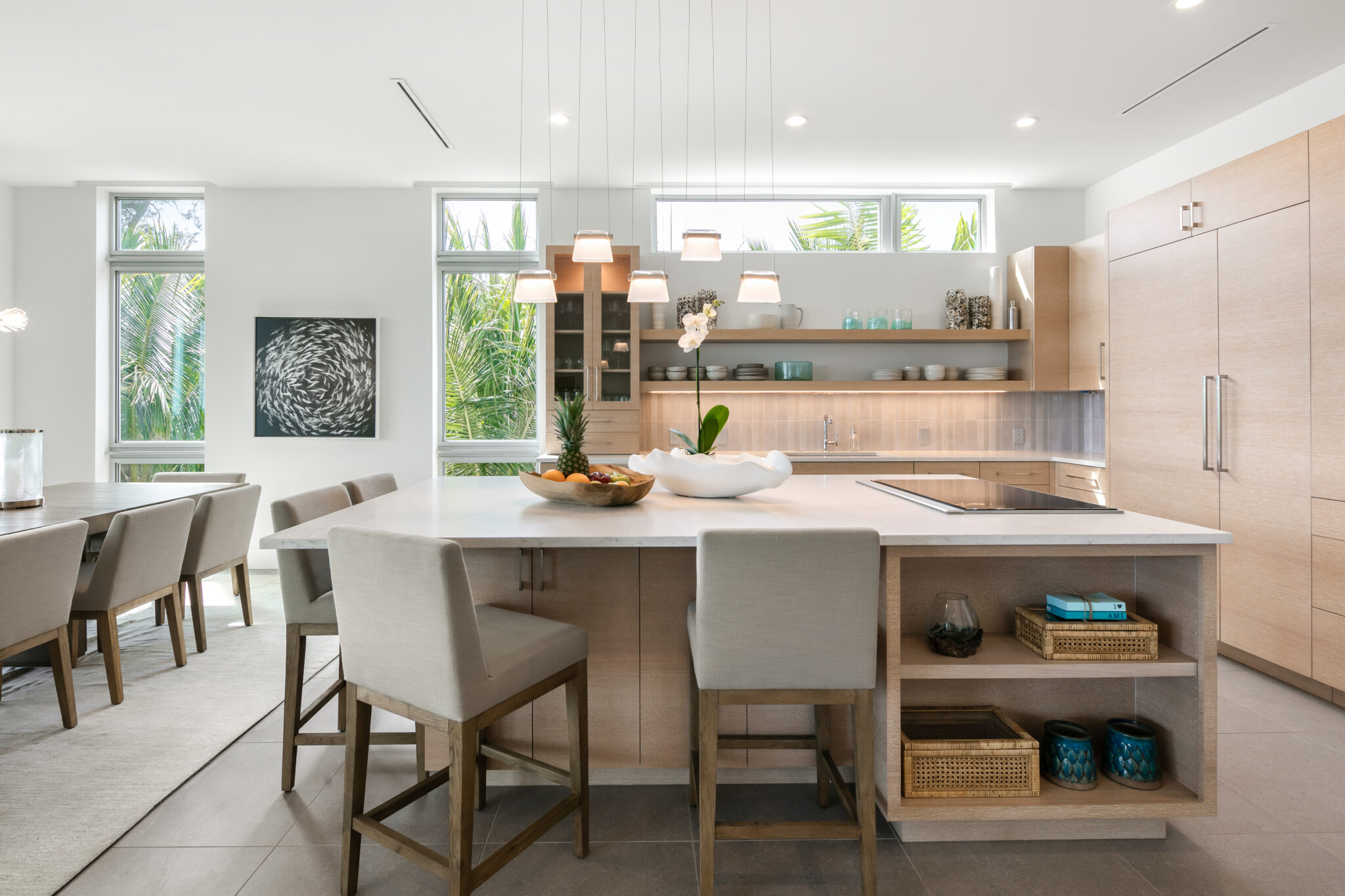 Kitchen island with seating and light wood cabinetry