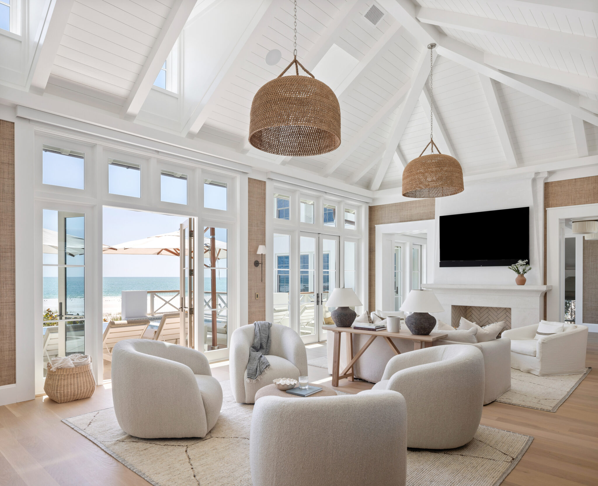 Living room seating facing walls of glass toward the Gulf