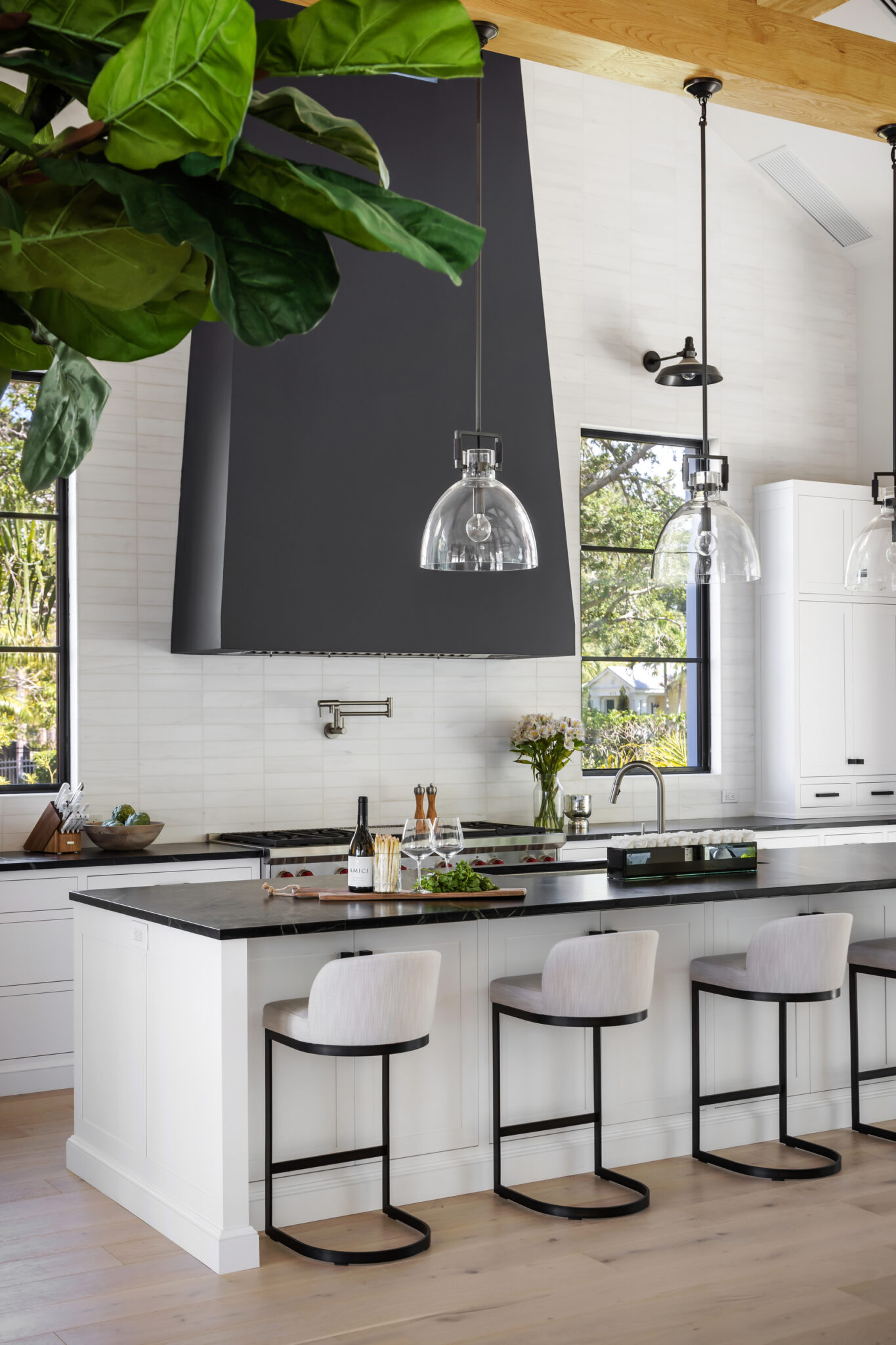 Kitchen bar with black counters and pendant lights