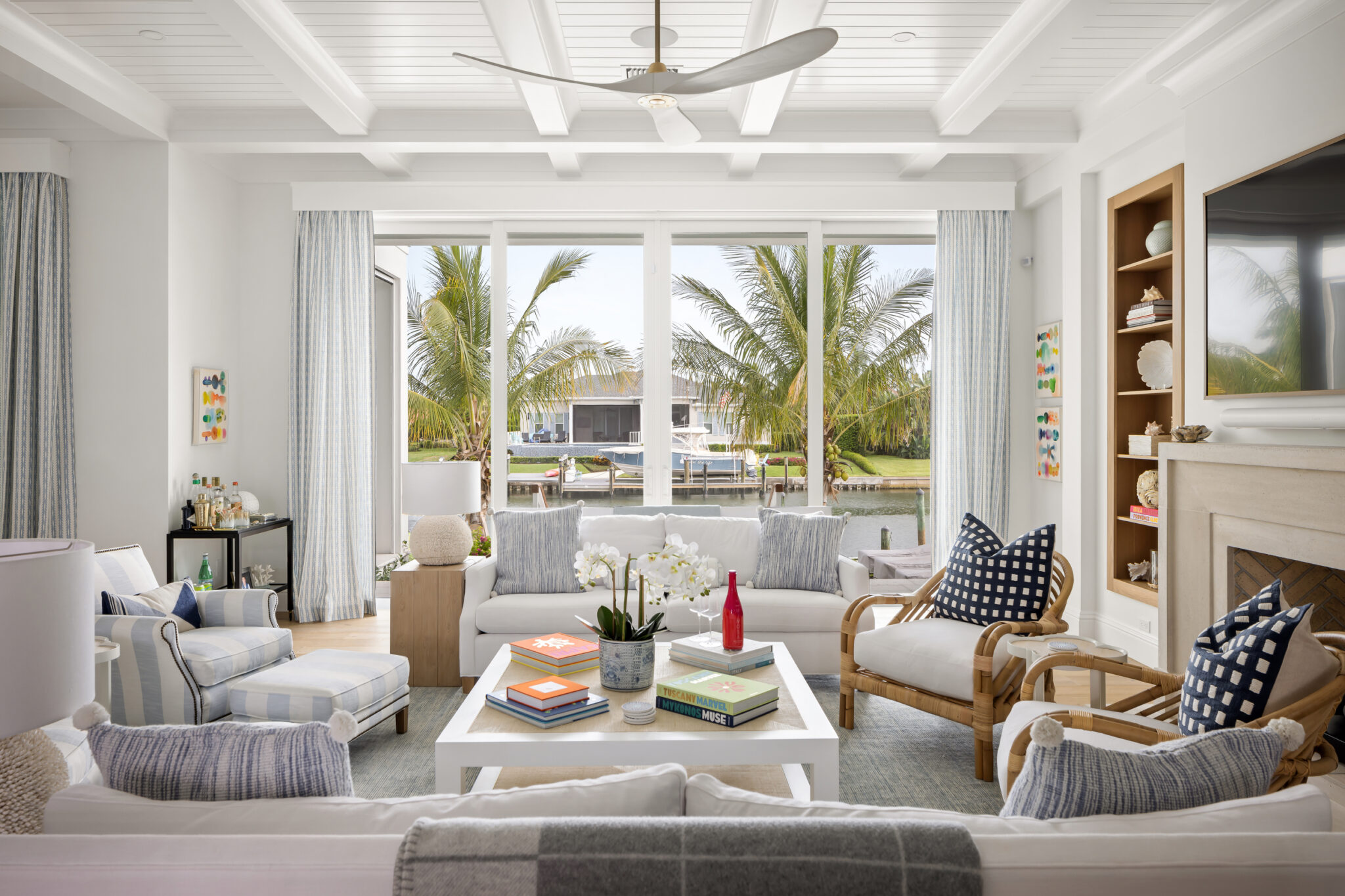 Living room with sliding glass to the canal and palms