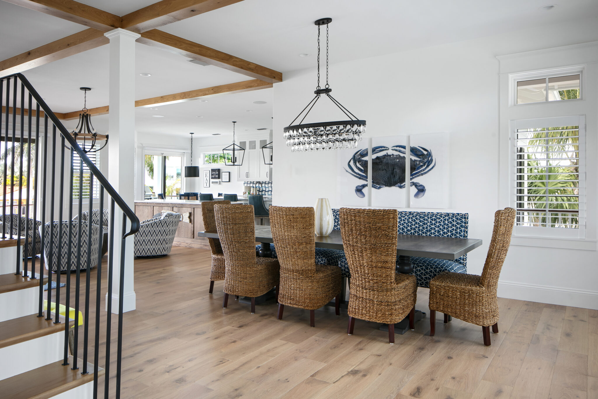 Dining table with woven chairs beside the stair