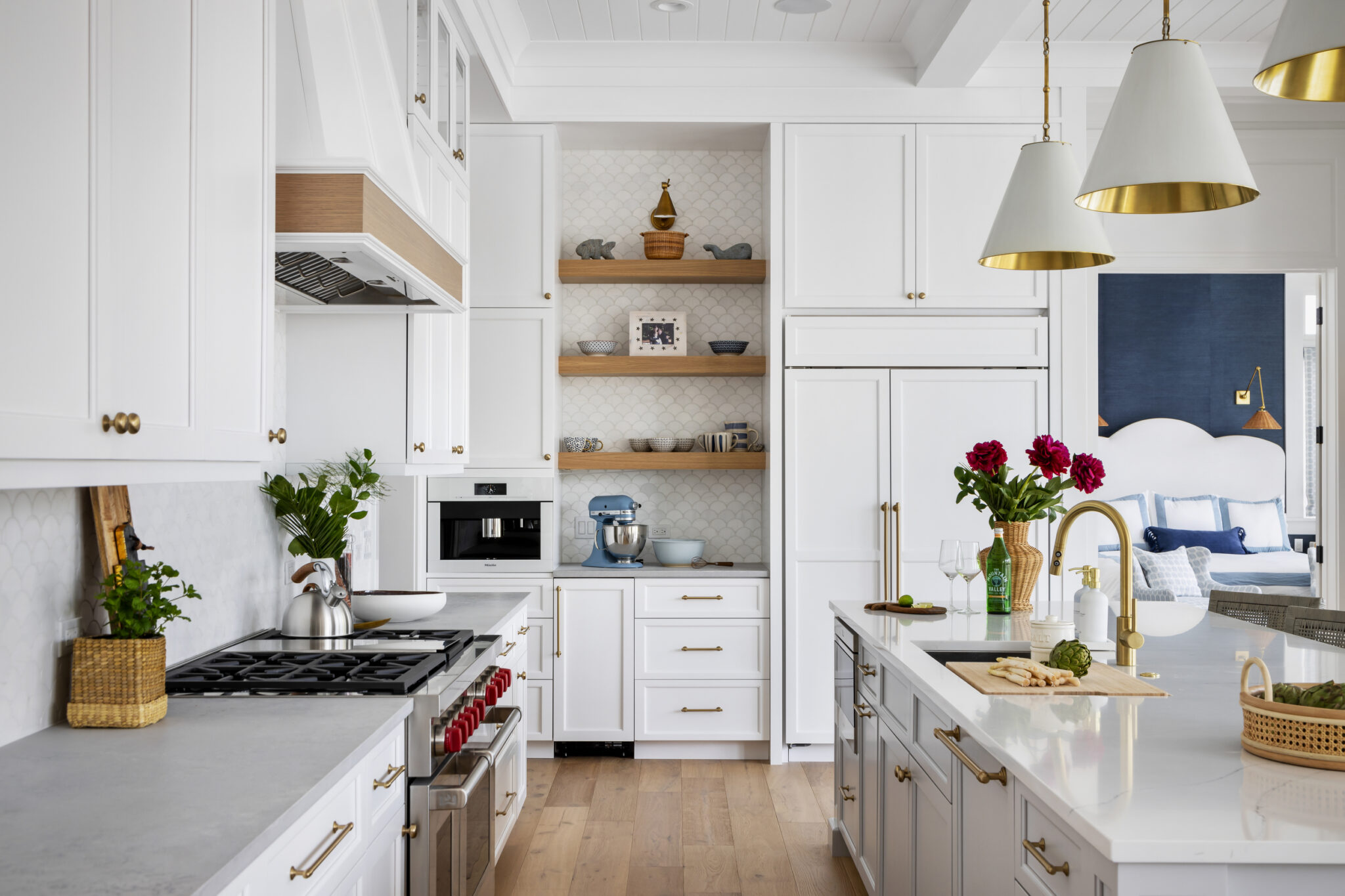 Kitchen with white cabinets, brass pendants and open shelves
