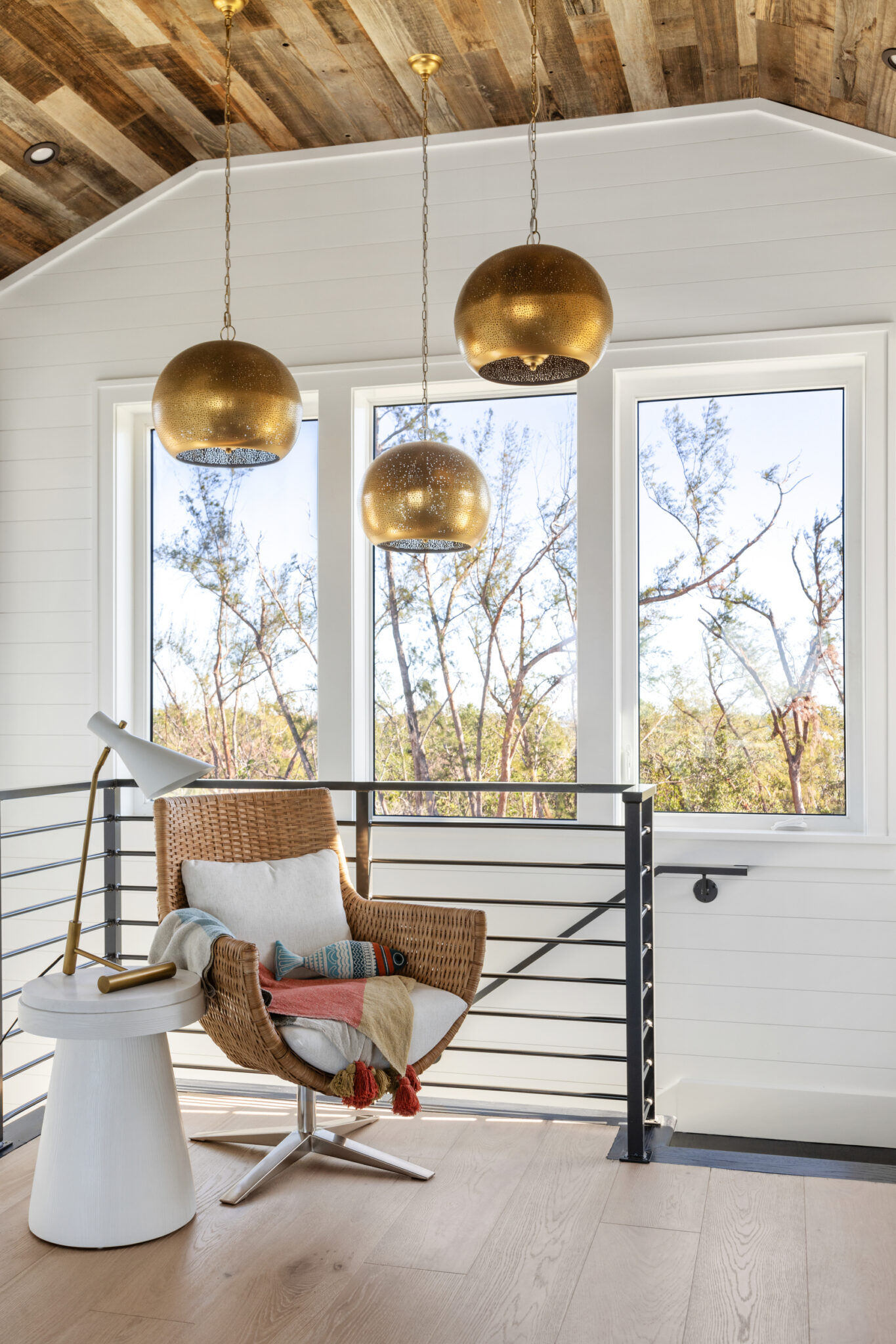 Stair landing reading nook with gold pendants