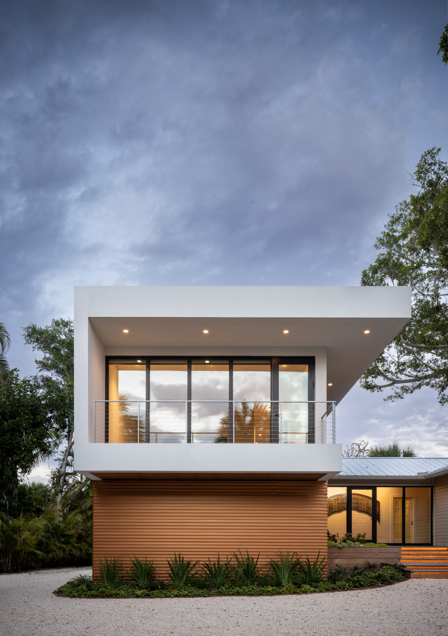 Front of the addition with floor-to-ceiling glass at dusk