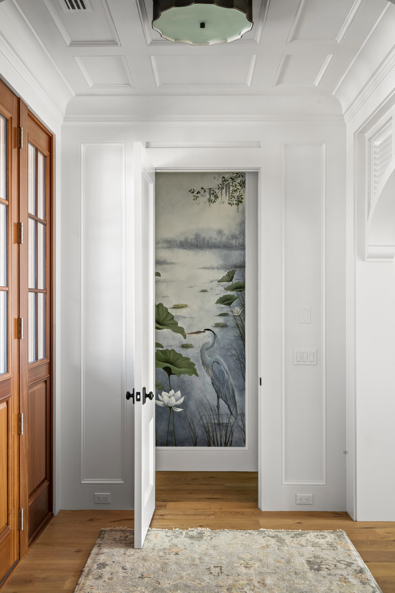 Entry hall with a wood door and a painted glass panel