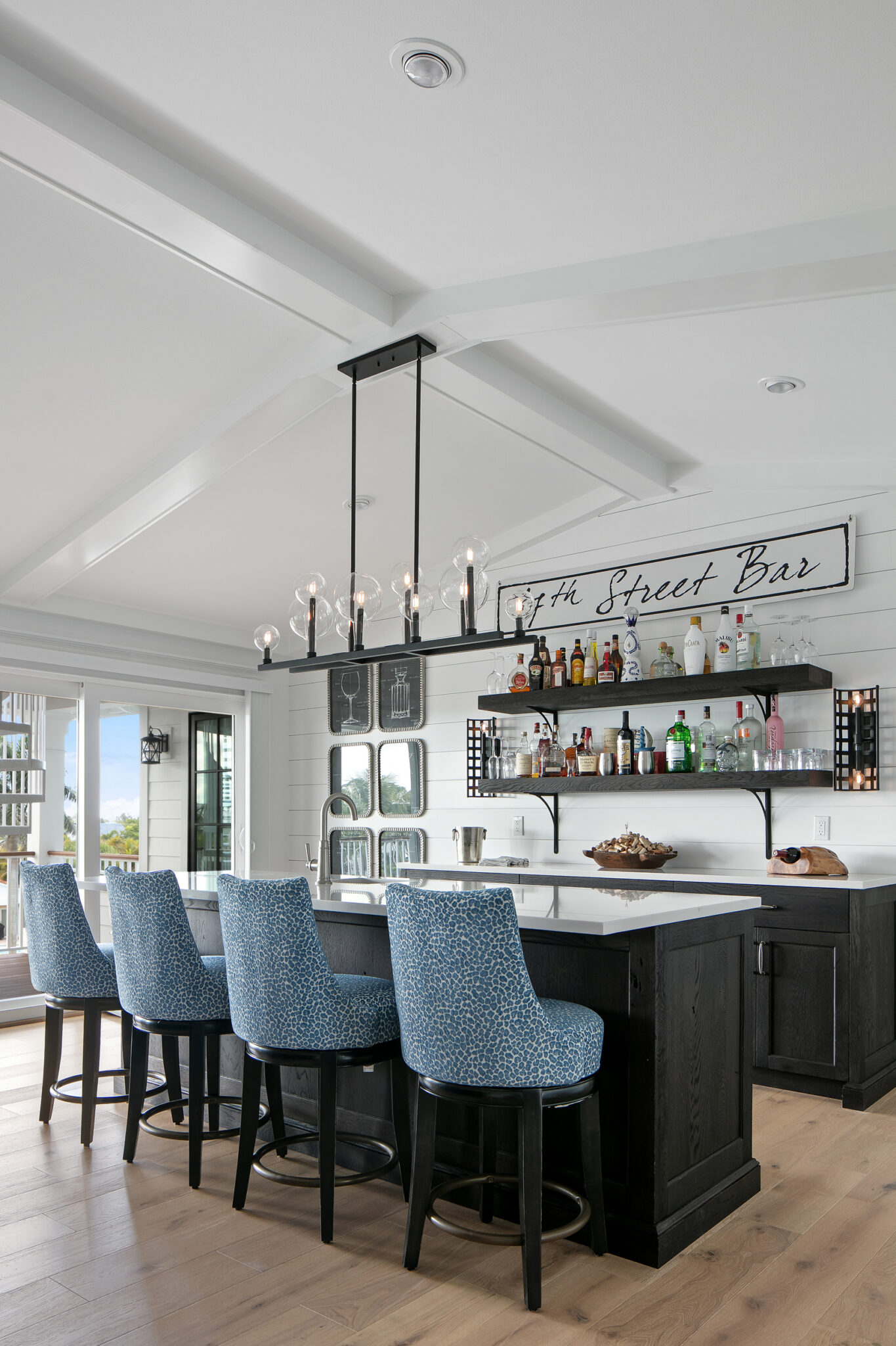 Bar with navy stools and open shelving