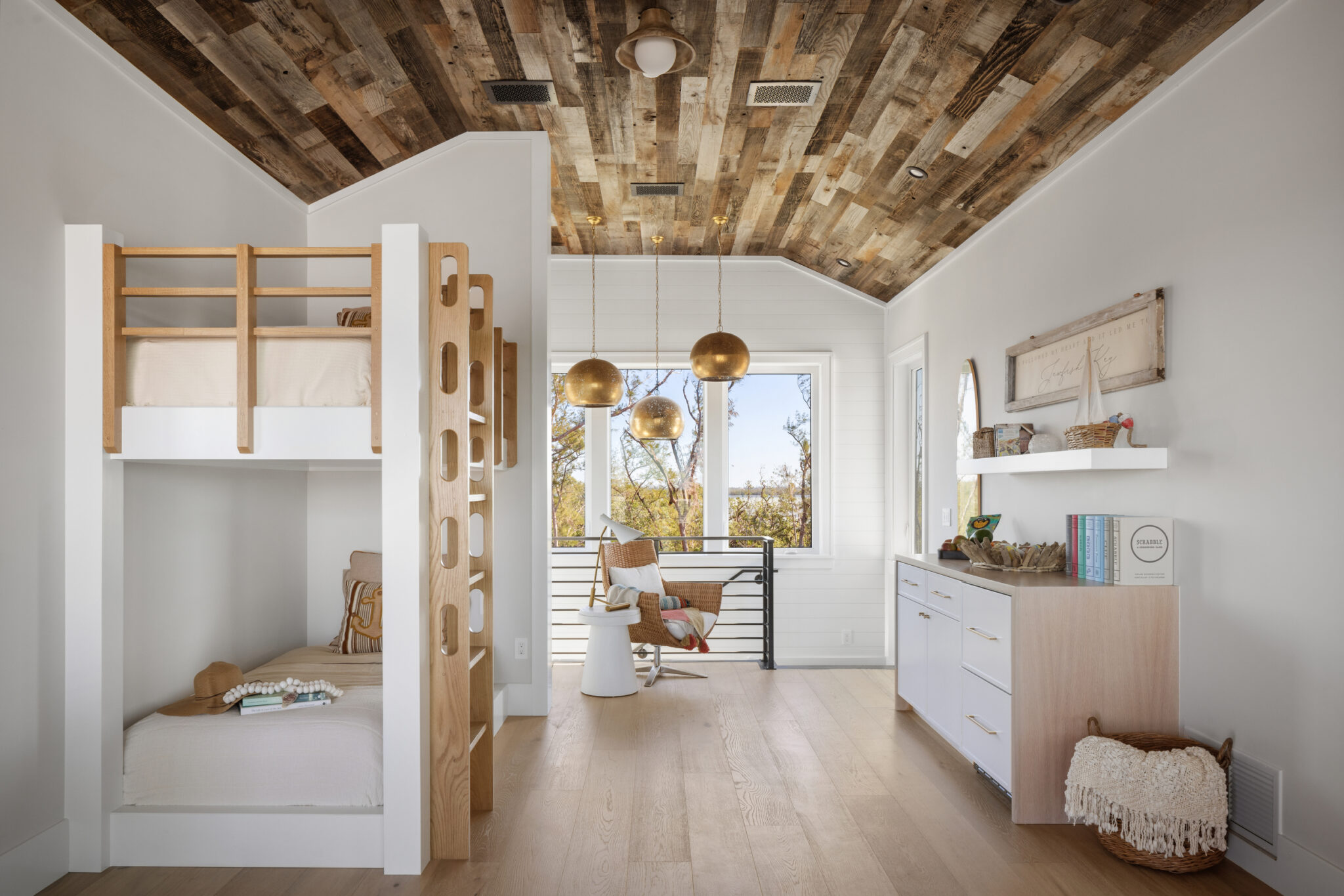 Bunk room with built-in oak bunks under a reclaimed-wood ceiling