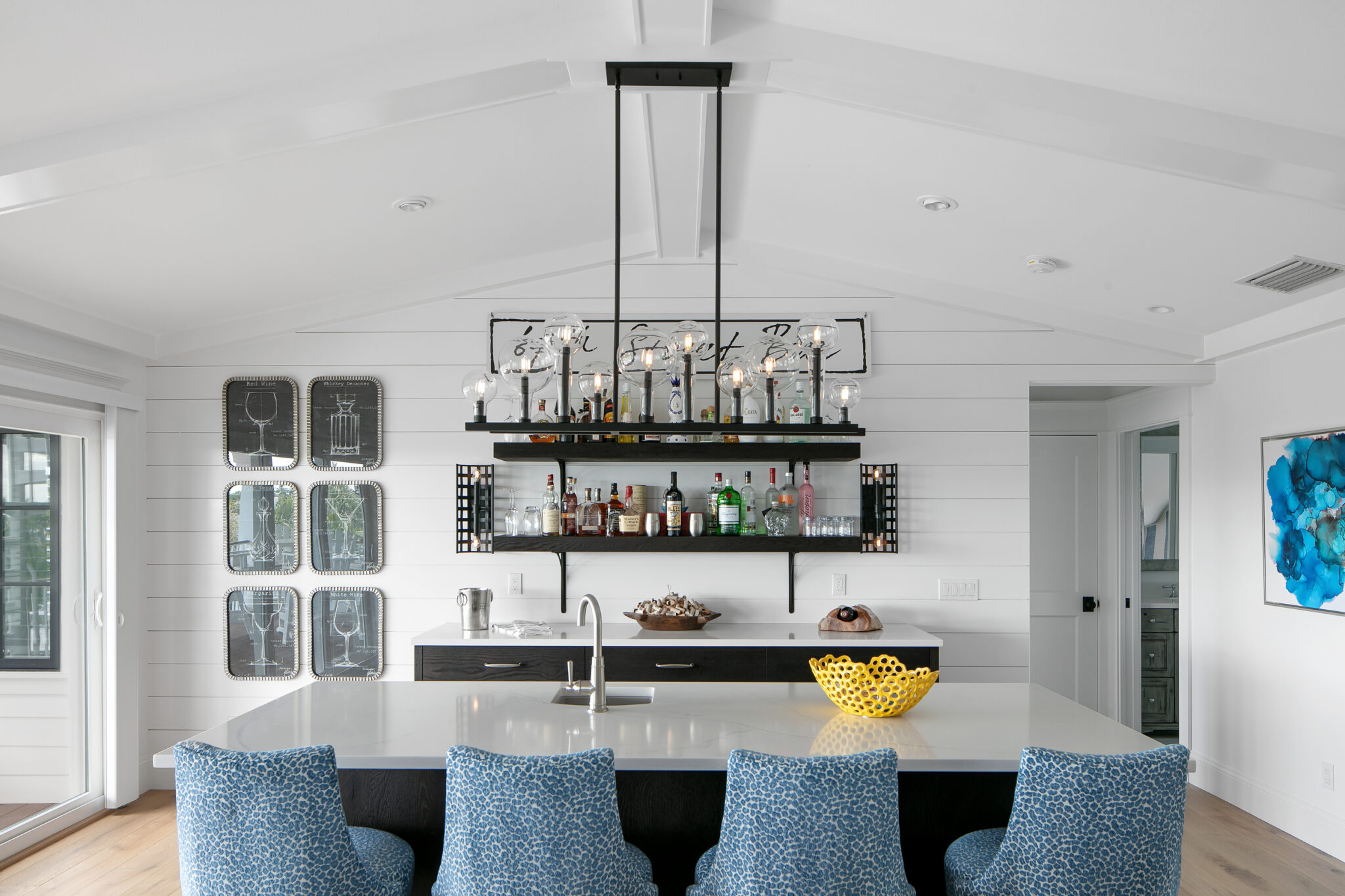 Bar with a hanging glass rack and blue stools