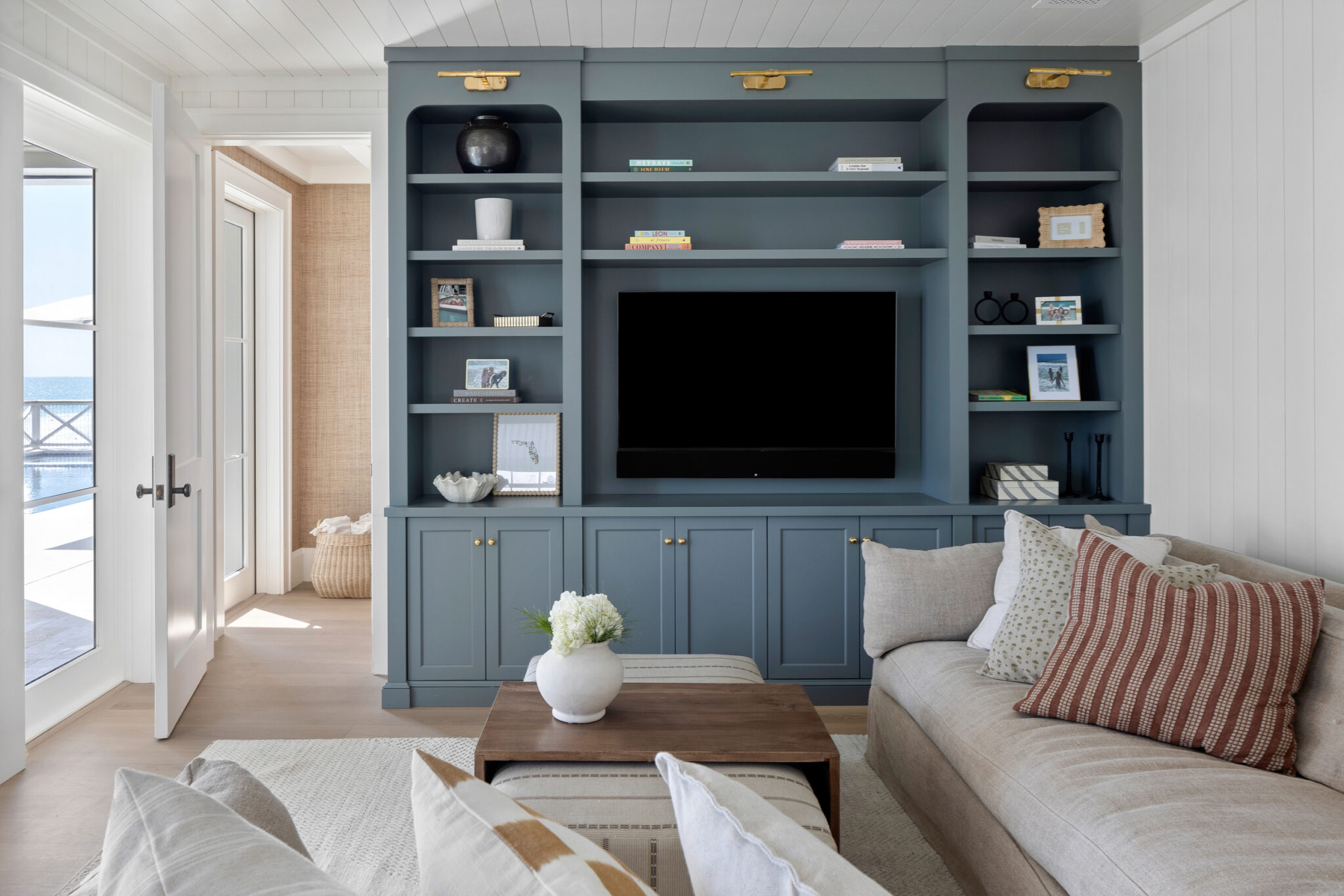 Family room with a built-in blue media wall and a linen sofa