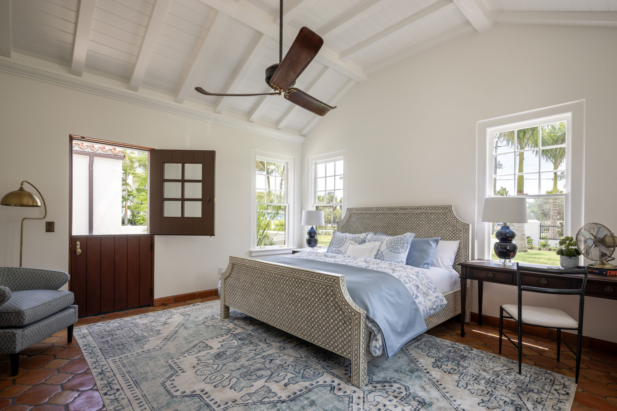 Bedroom with a Dutch door and a vintage rug