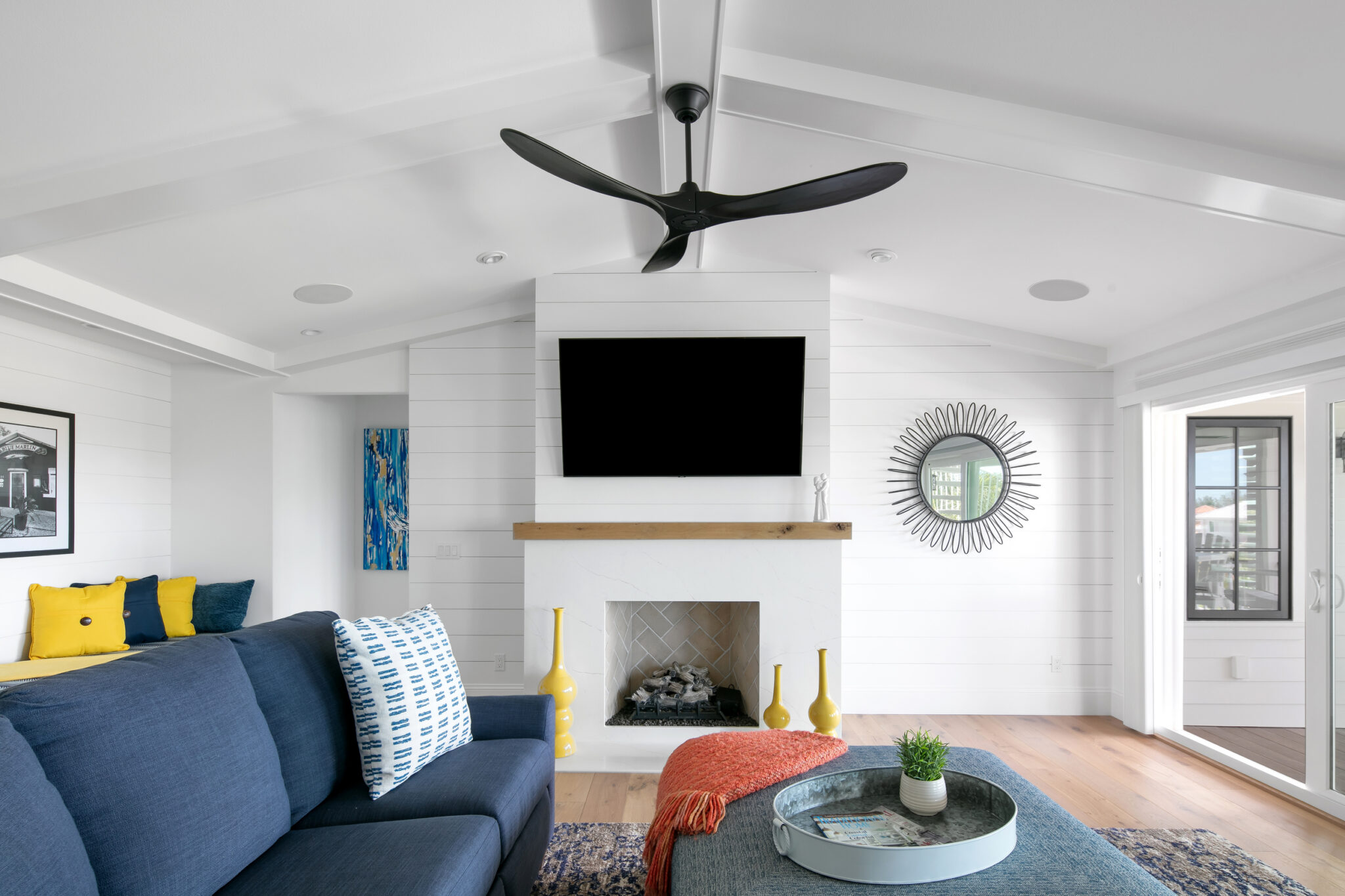 Family room with a navy sofa and fireplace
