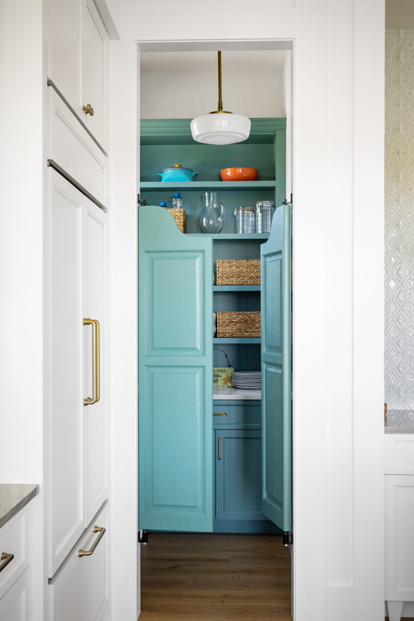 Pantry with a teal door and open shelves