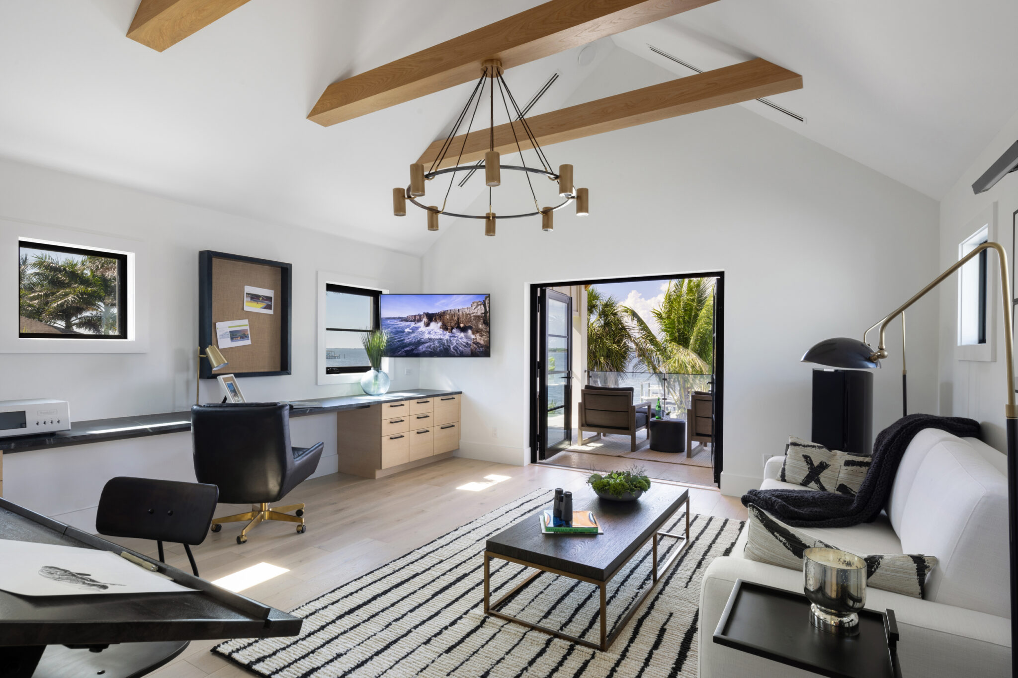 Office and sitting room under a timber beam with a ring chandelier