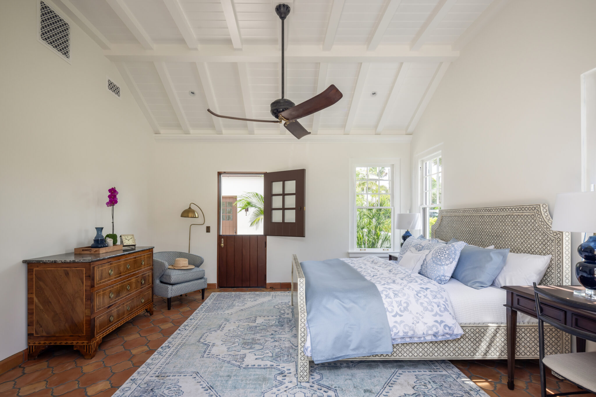 Bedroom with a beamed ceiling, ceiling fan and Dutch door