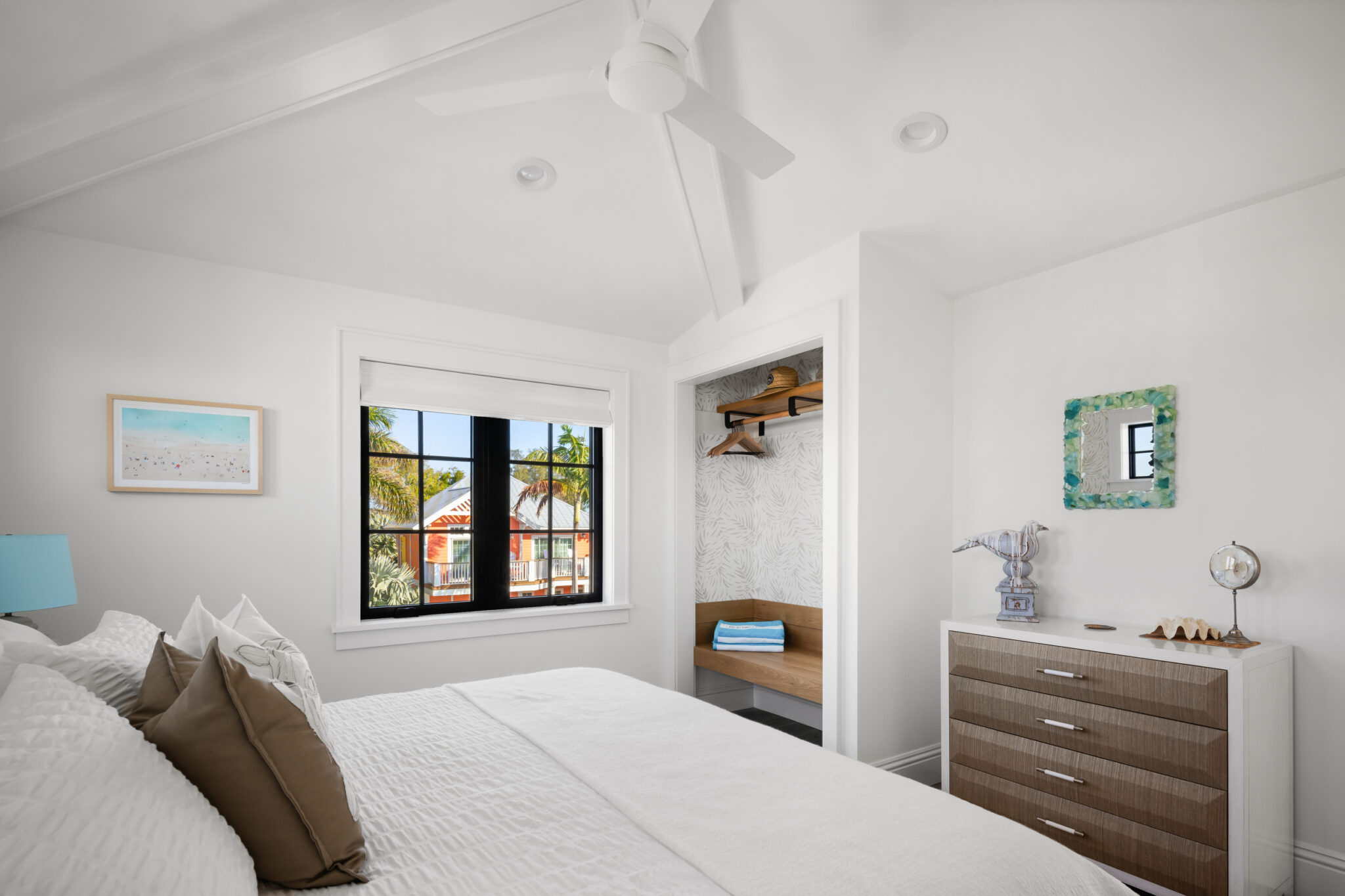 Bedroom with black windows and a striped dresser