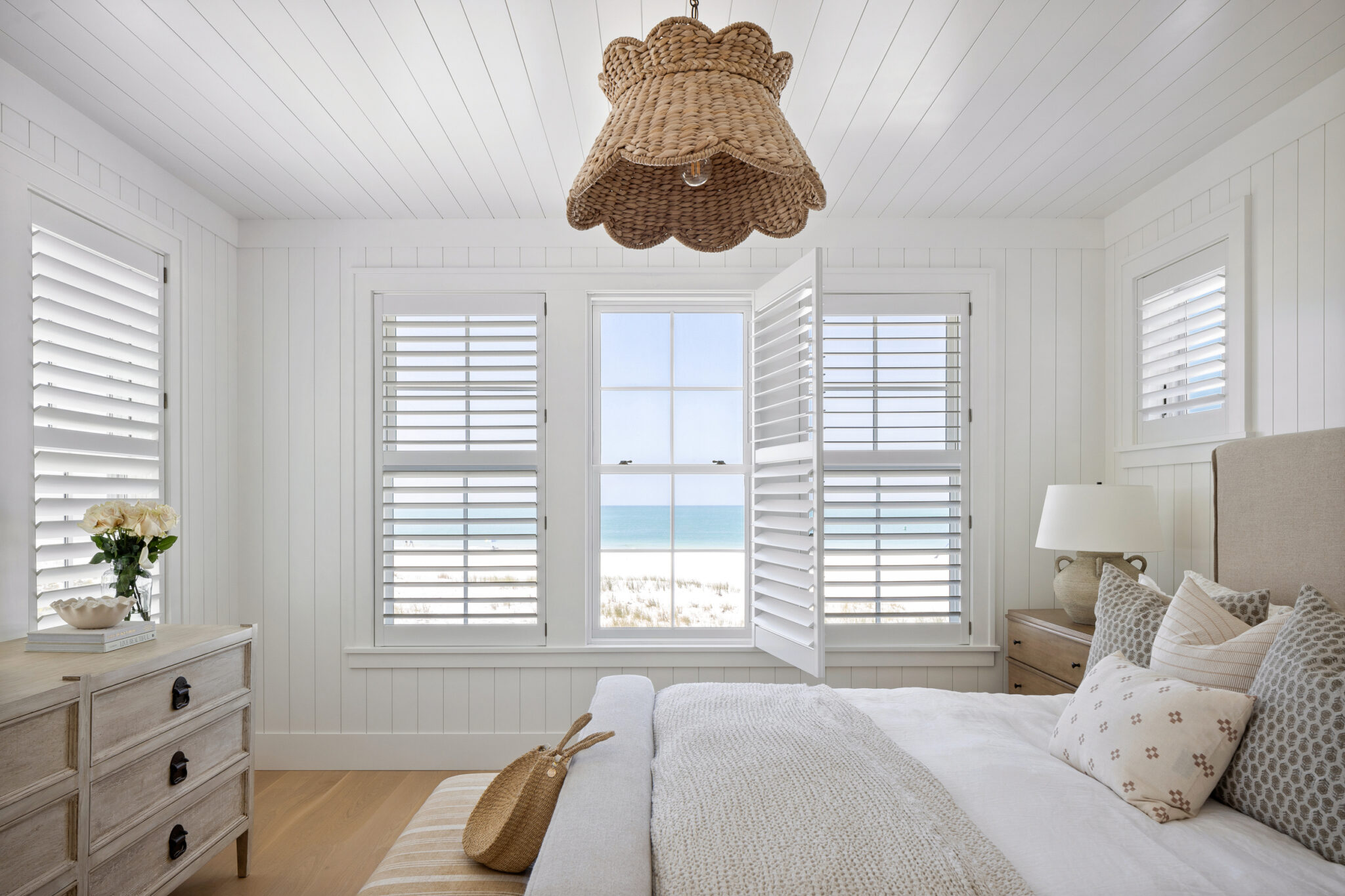 Bedroom with plantation shutters and a view of the Gulf