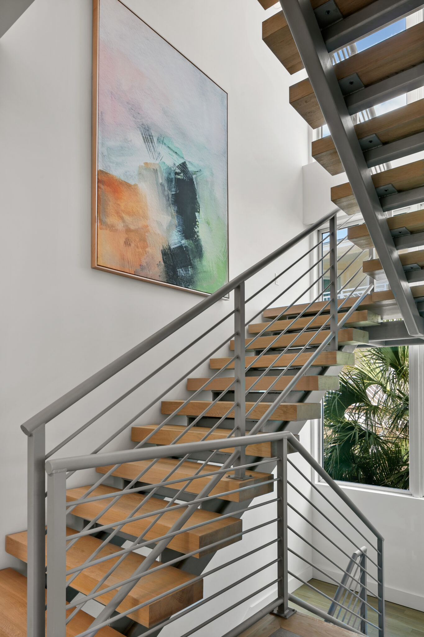 Open wood stair with a steel railing