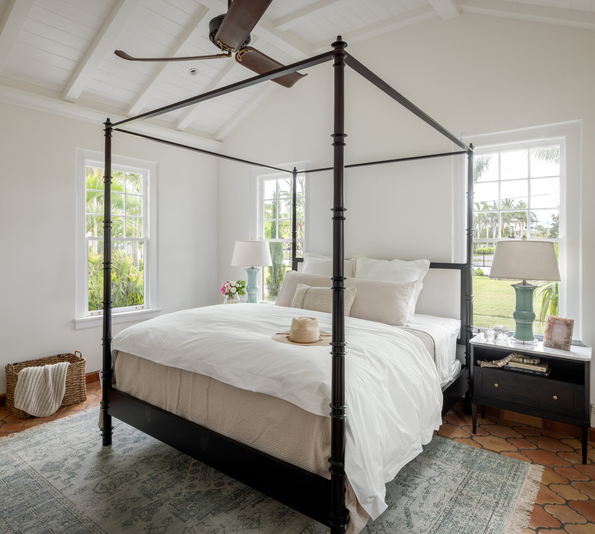 Bedroom with a black four-poster bed under a beamed ceiling
