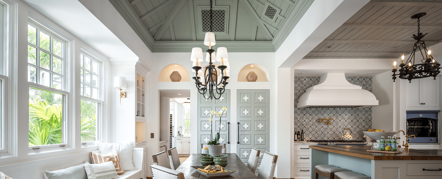 Kitchen and breakfast room with terracotta floors and wrought-iron chandeliers at the Van Wezel Estate