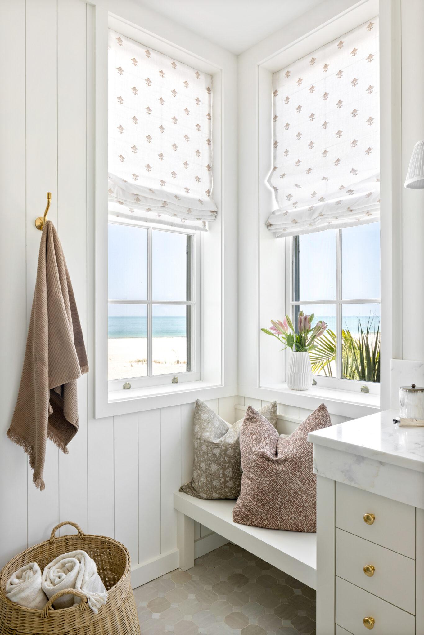 Bathroom window seat with a built-in vanity and towel hooks