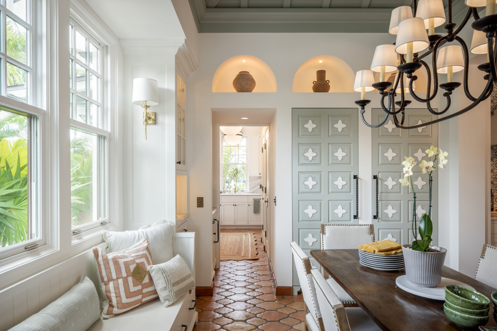 Breakfast nook with a window seat and patterned cabinet doors