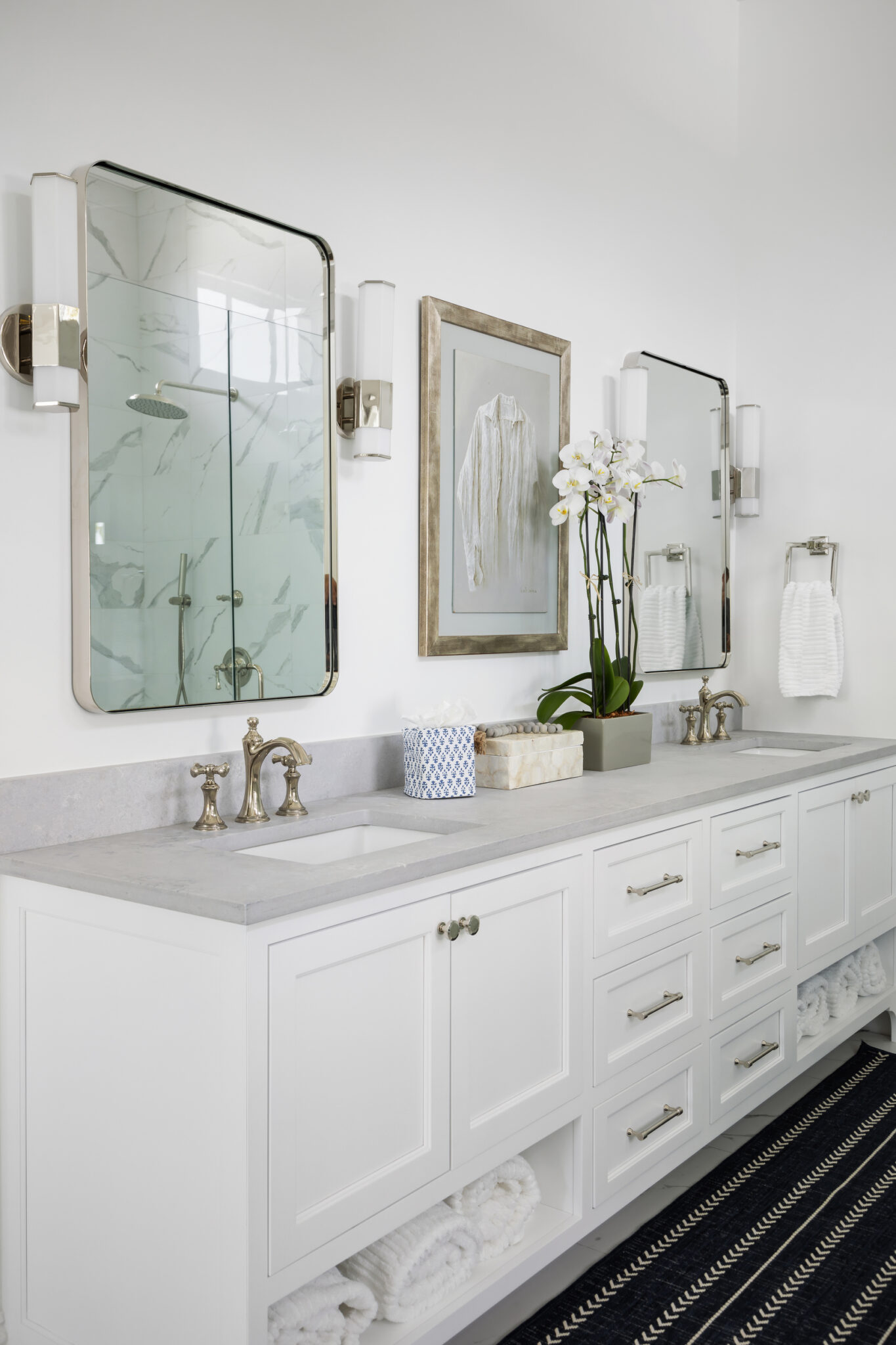Bath vanity with a brass-framed mirror