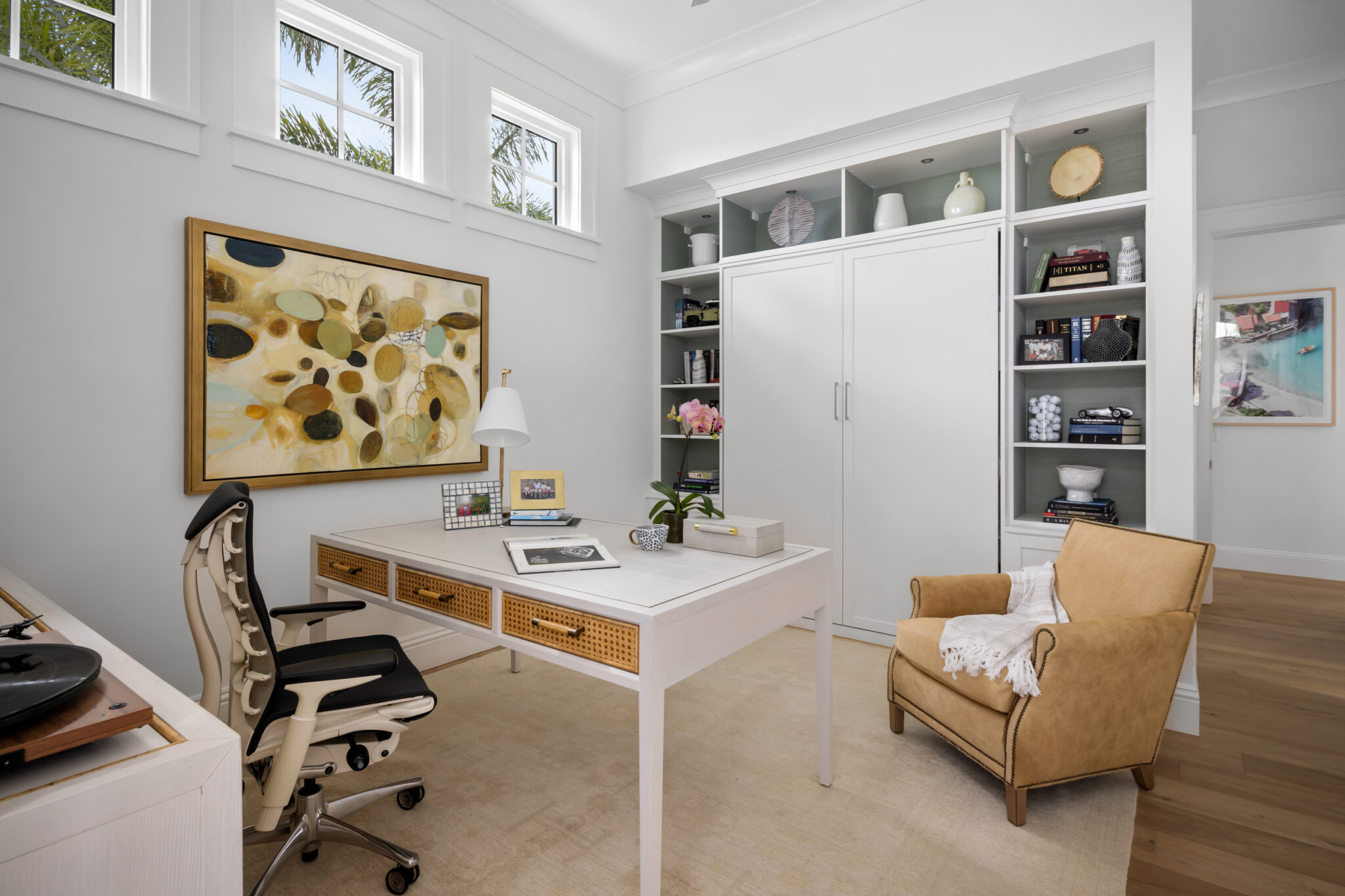 Home office with a white desk and built-in shelves