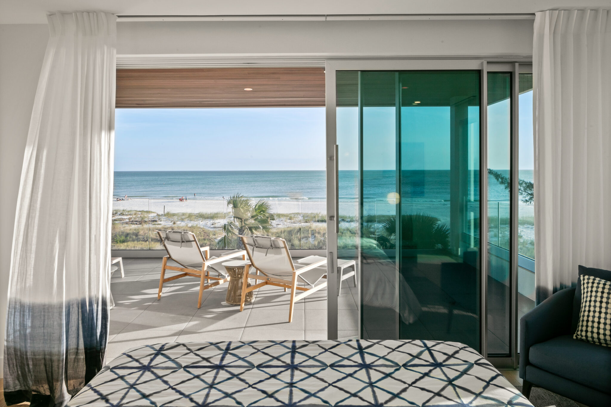 Bedroom with sliding glass doors to a Gulf-view balcony