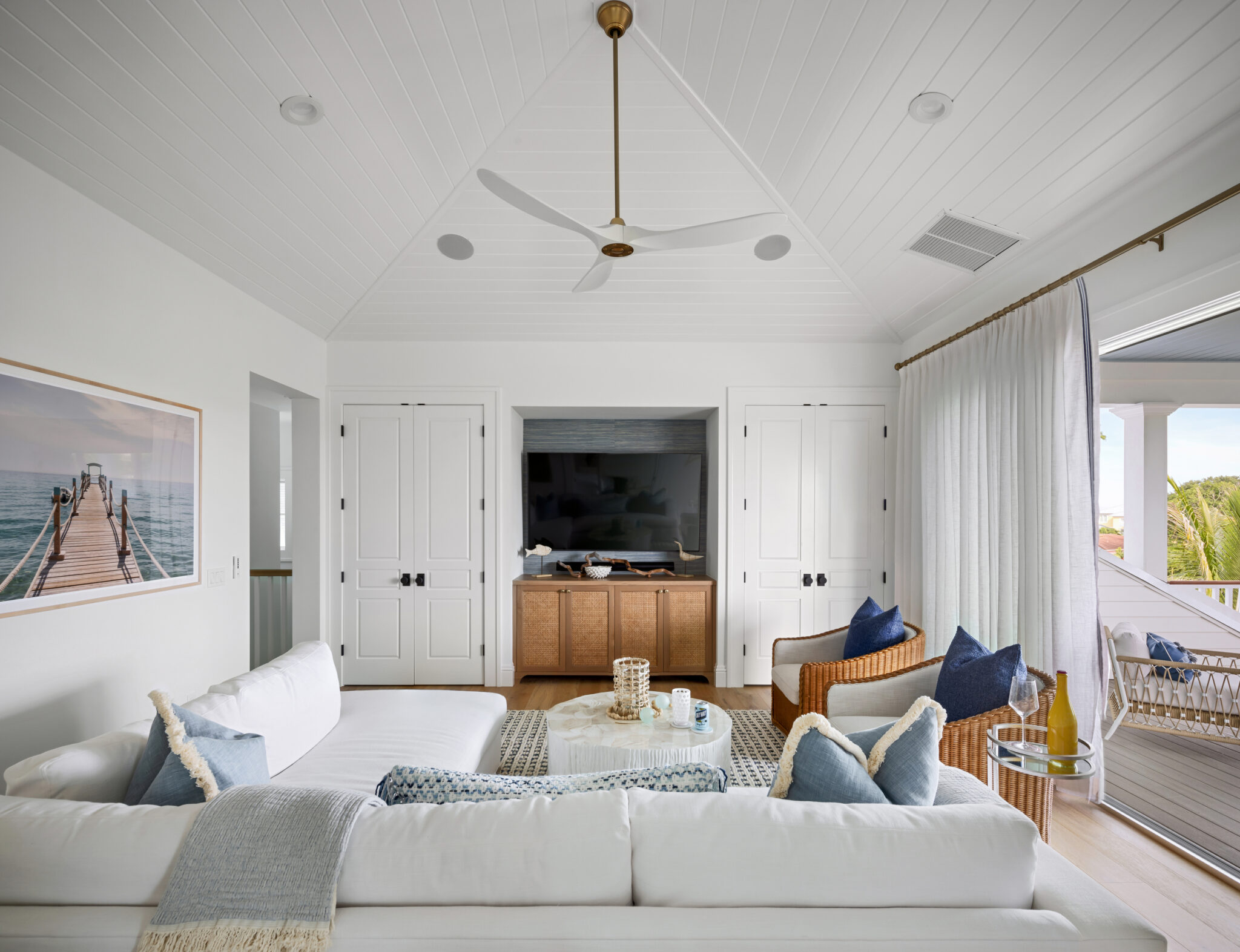 Sitting room with a white sofa and built-in media wall