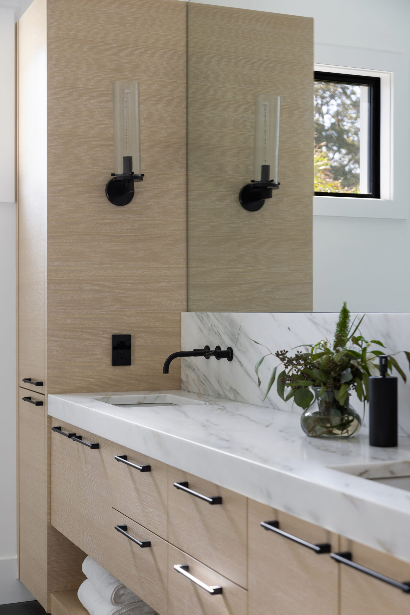 Oak vanity with black fixtures and marble counter