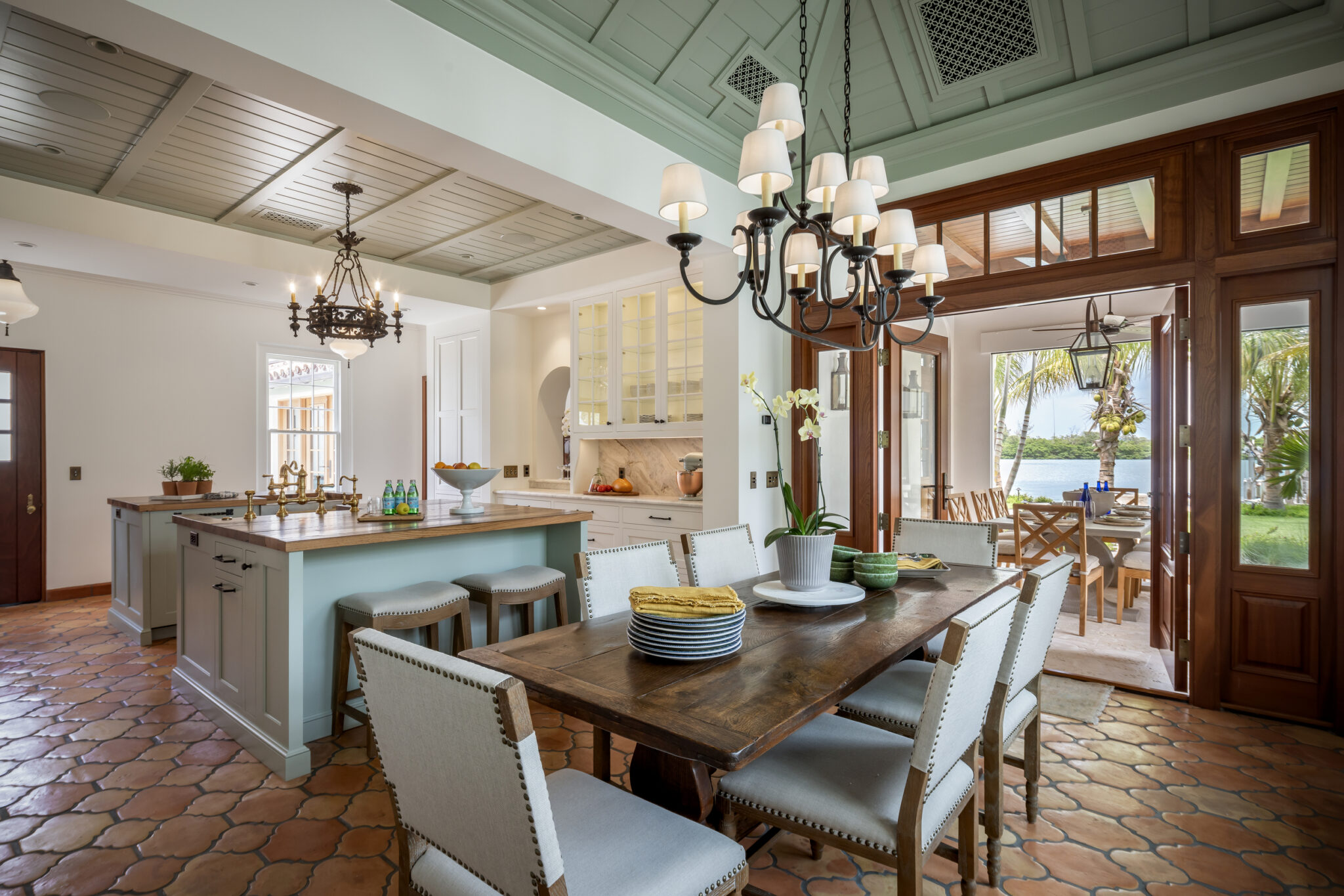 Kitchen and dining area opening to the patio through wood doors