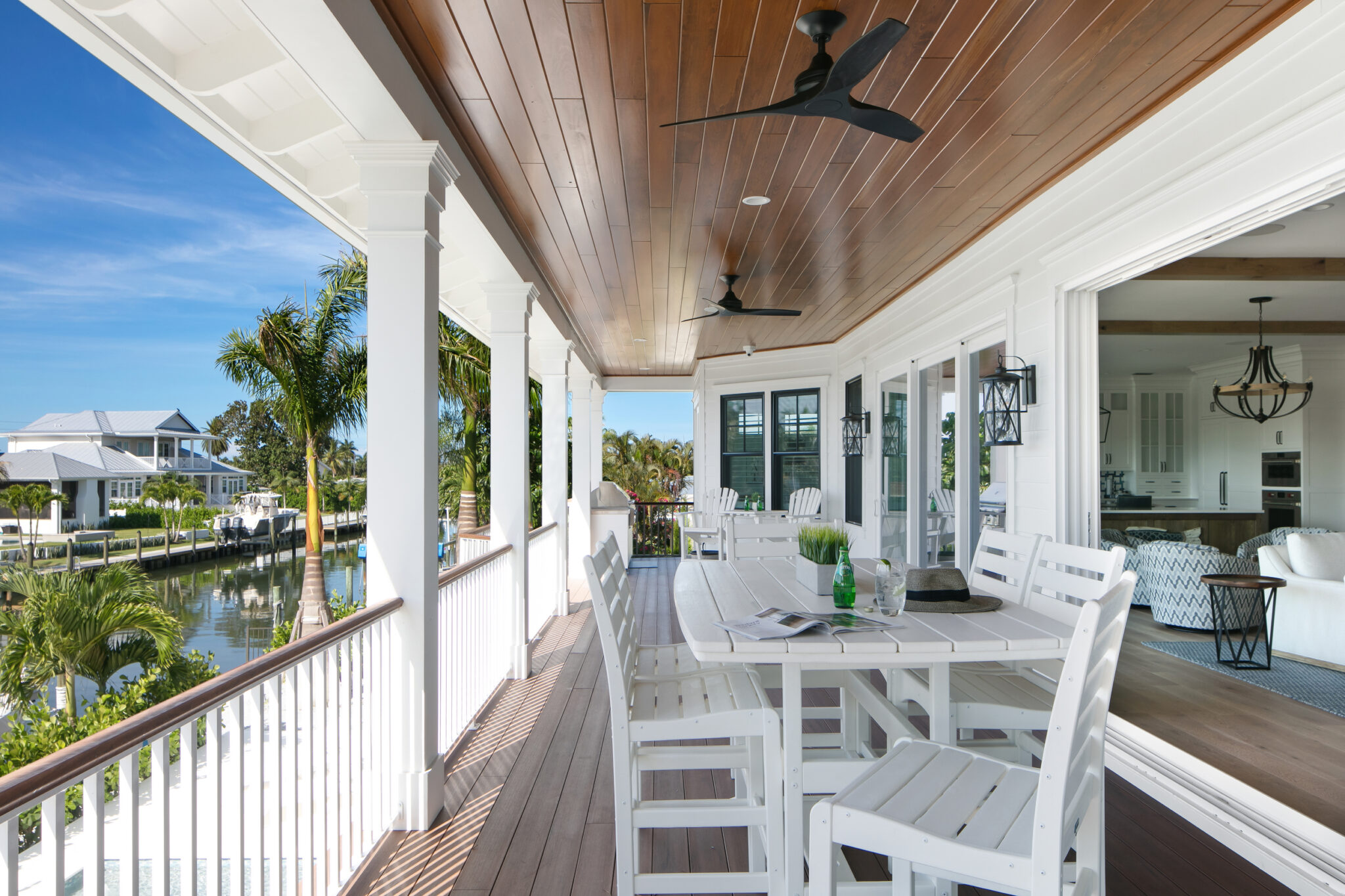 Porch dining table under a wood ceiling with canal views
