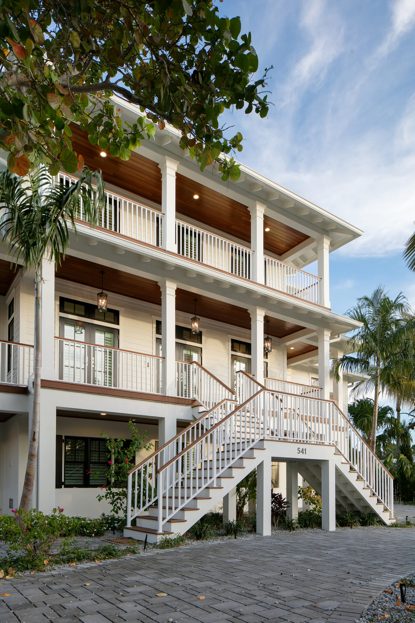 Exterior stair rising to the wraparound porches of Coastal Haven