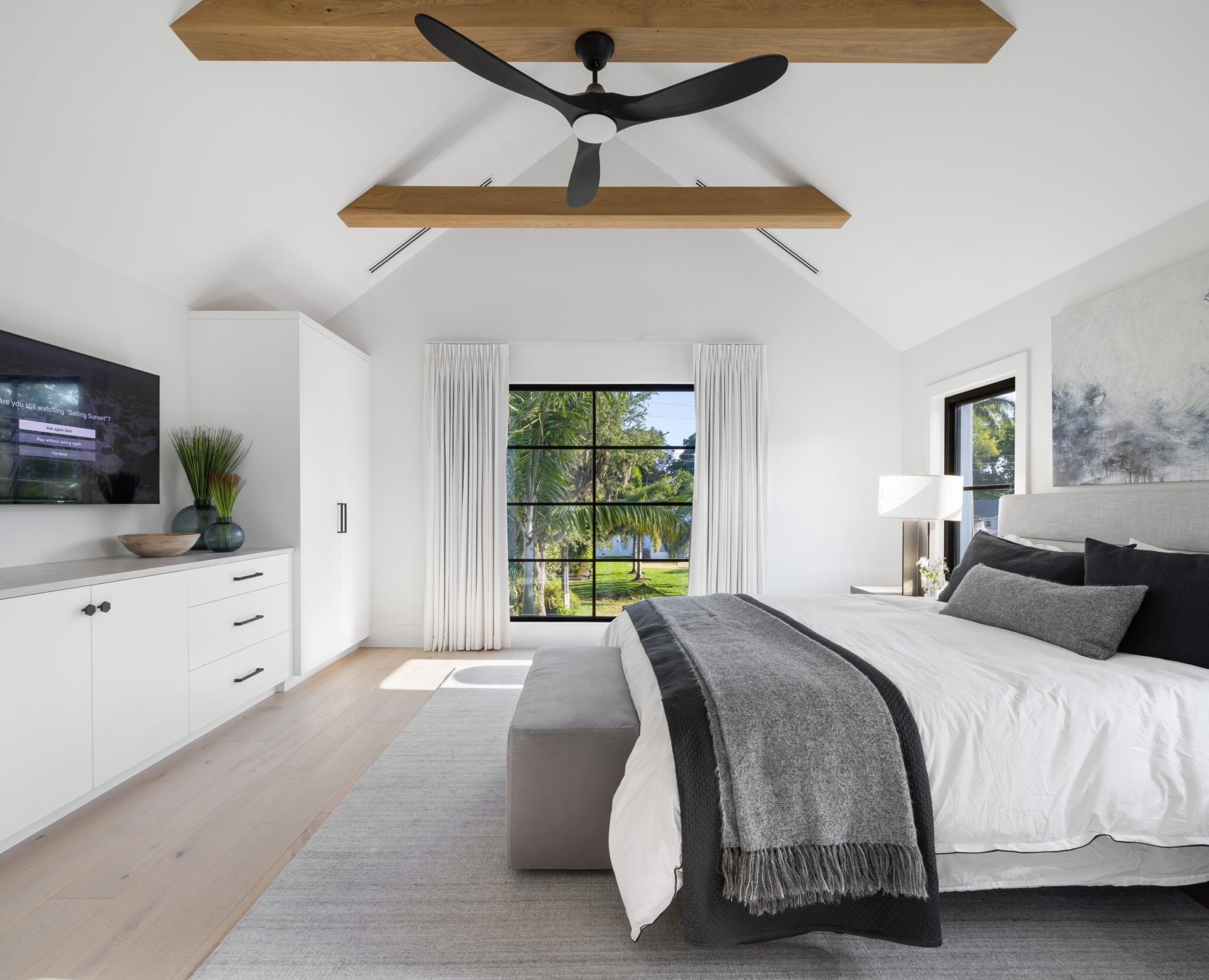 Bedroom under a vaulted ceiling with timber beams