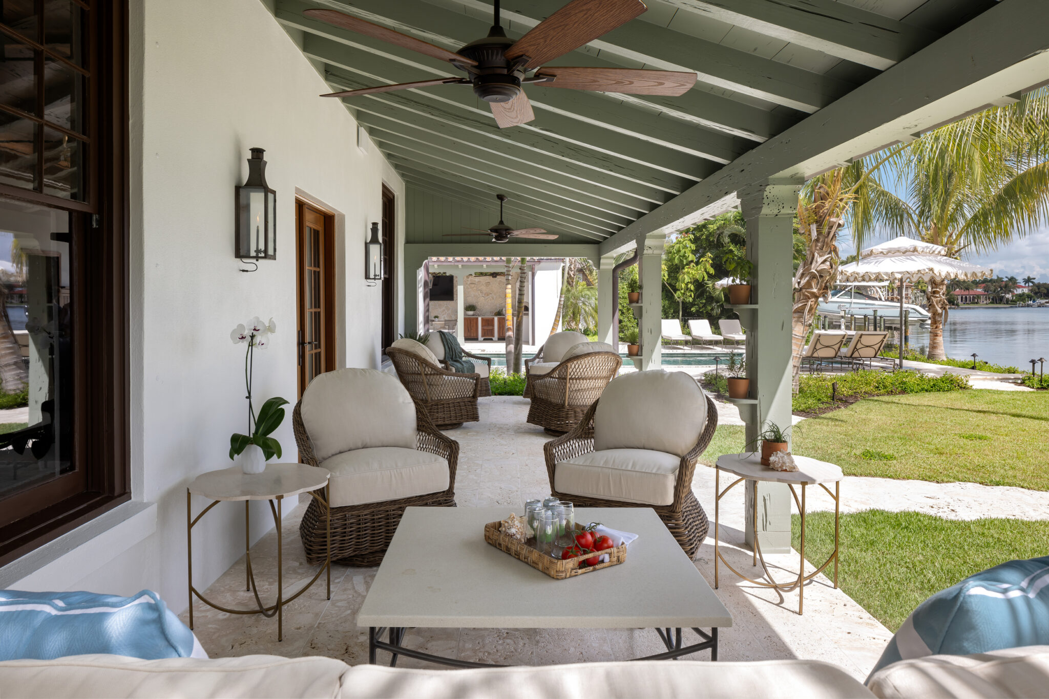 Covered porch seating overlooking the lawn and bay