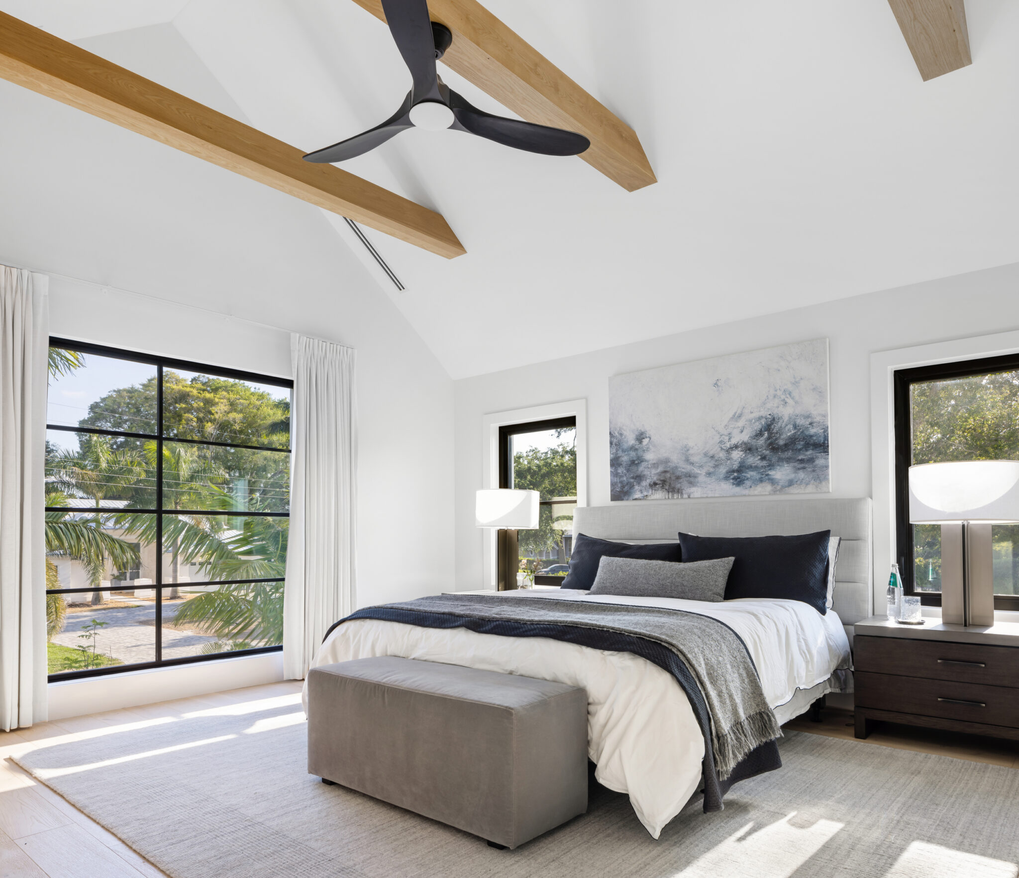 Bedroom with tall black windows and a vaulted ceiling